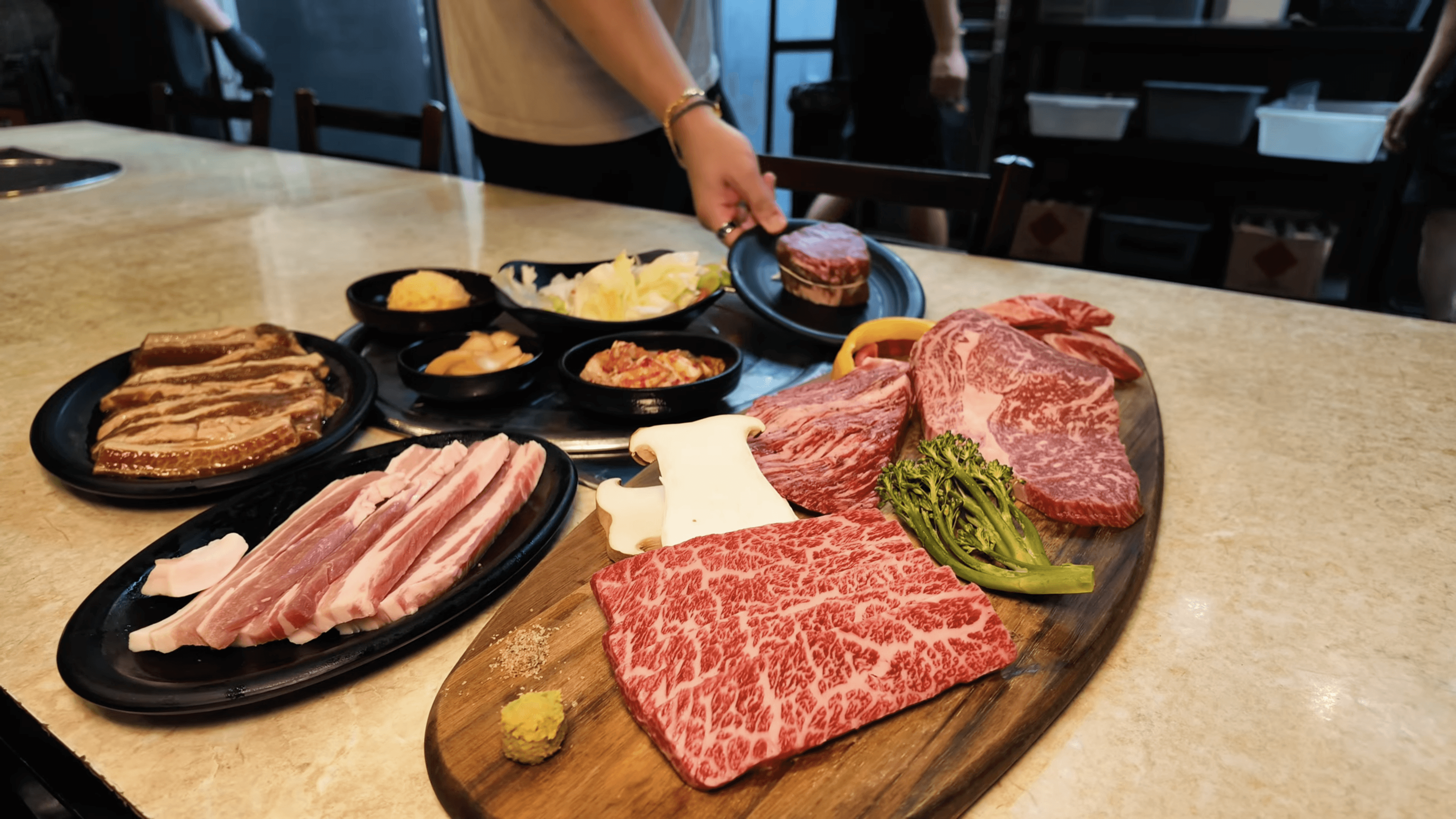 A beautifully plated dish featuring shrimp, colorful vegetables, and garnishes, set in a modern restaurant.