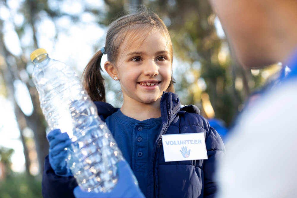 Child holding a water bottle for the Water Project