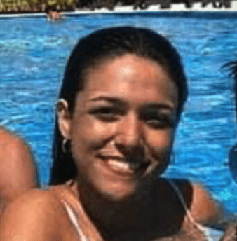 a man with a goatee smiles at the camera