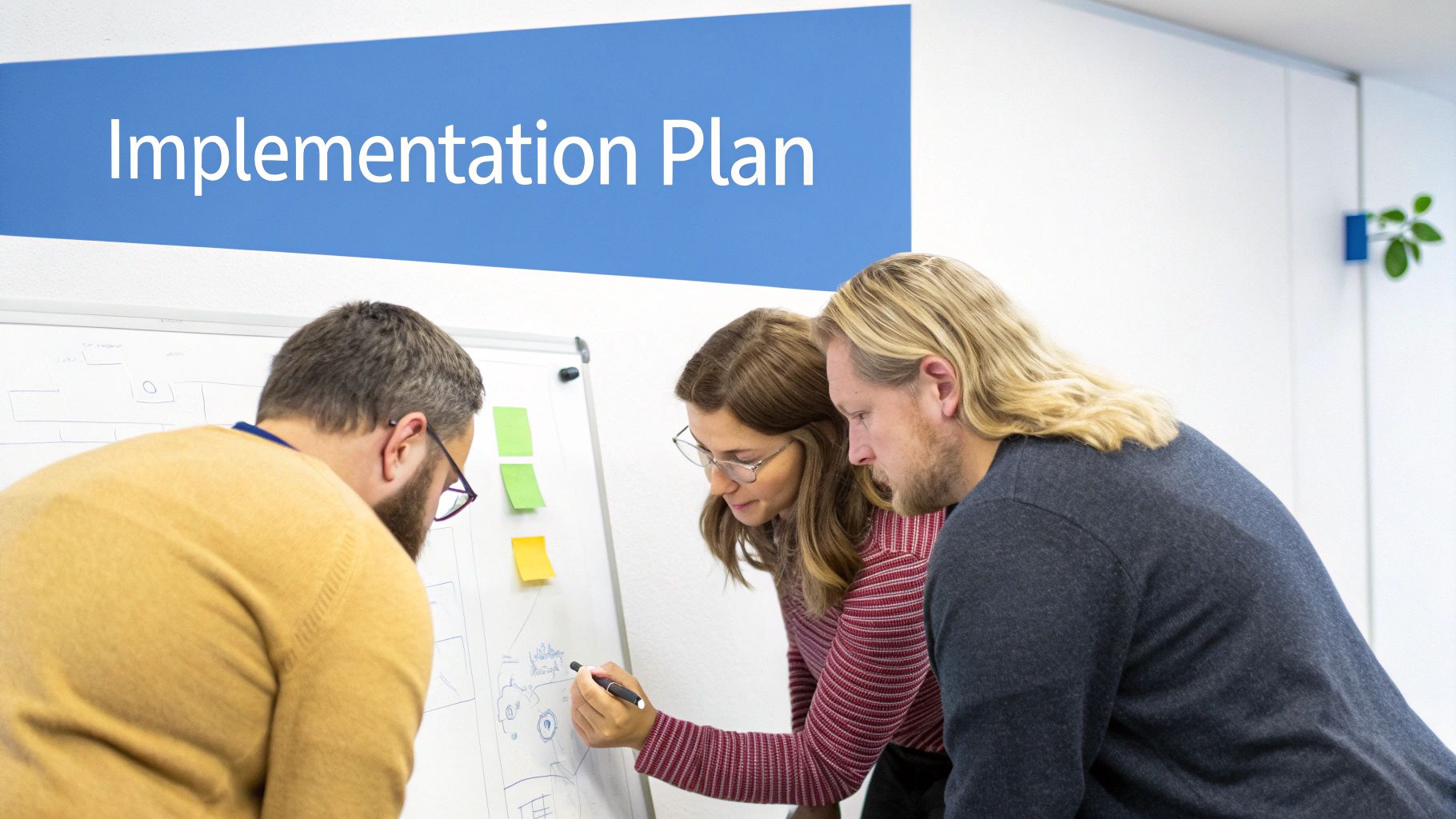 A person at a desk sketching out a strategic plan on a large piece of paper with sticky notes and diagrams.