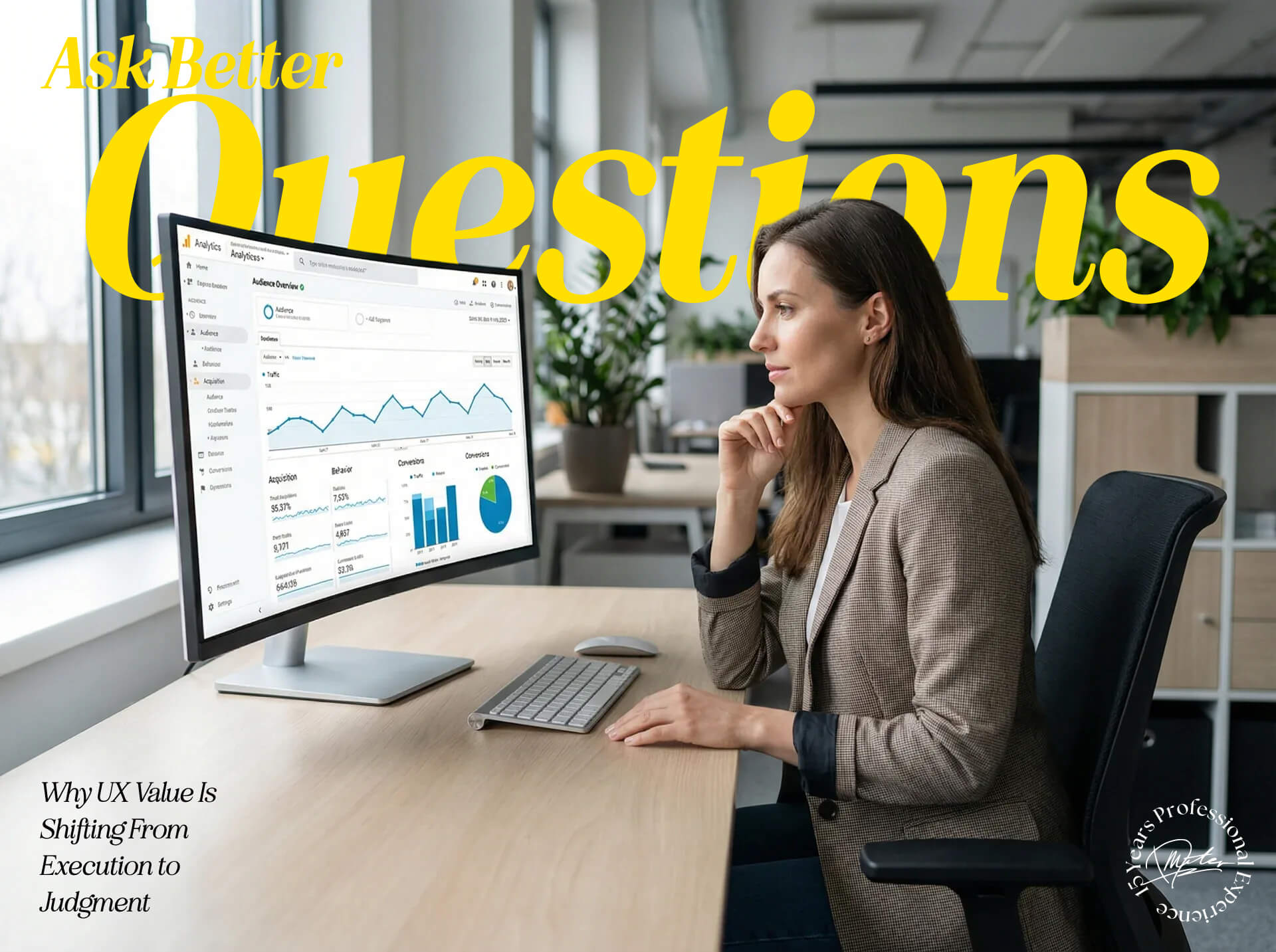 A UX professional seated at a desk, studying a Google Analytics dashboard with traffic trends, charts, and performance metrics on a large monitor in a modern office.