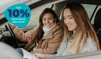 Young Driver just past her driving test smiling in vehicle with black box telematics car insurance
