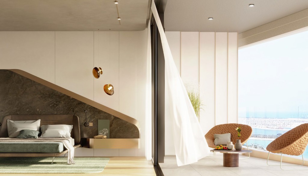 A modern bedroom featuring large windows with a stunning view of the ocean, showcasing the elegance of Iconic Residences.