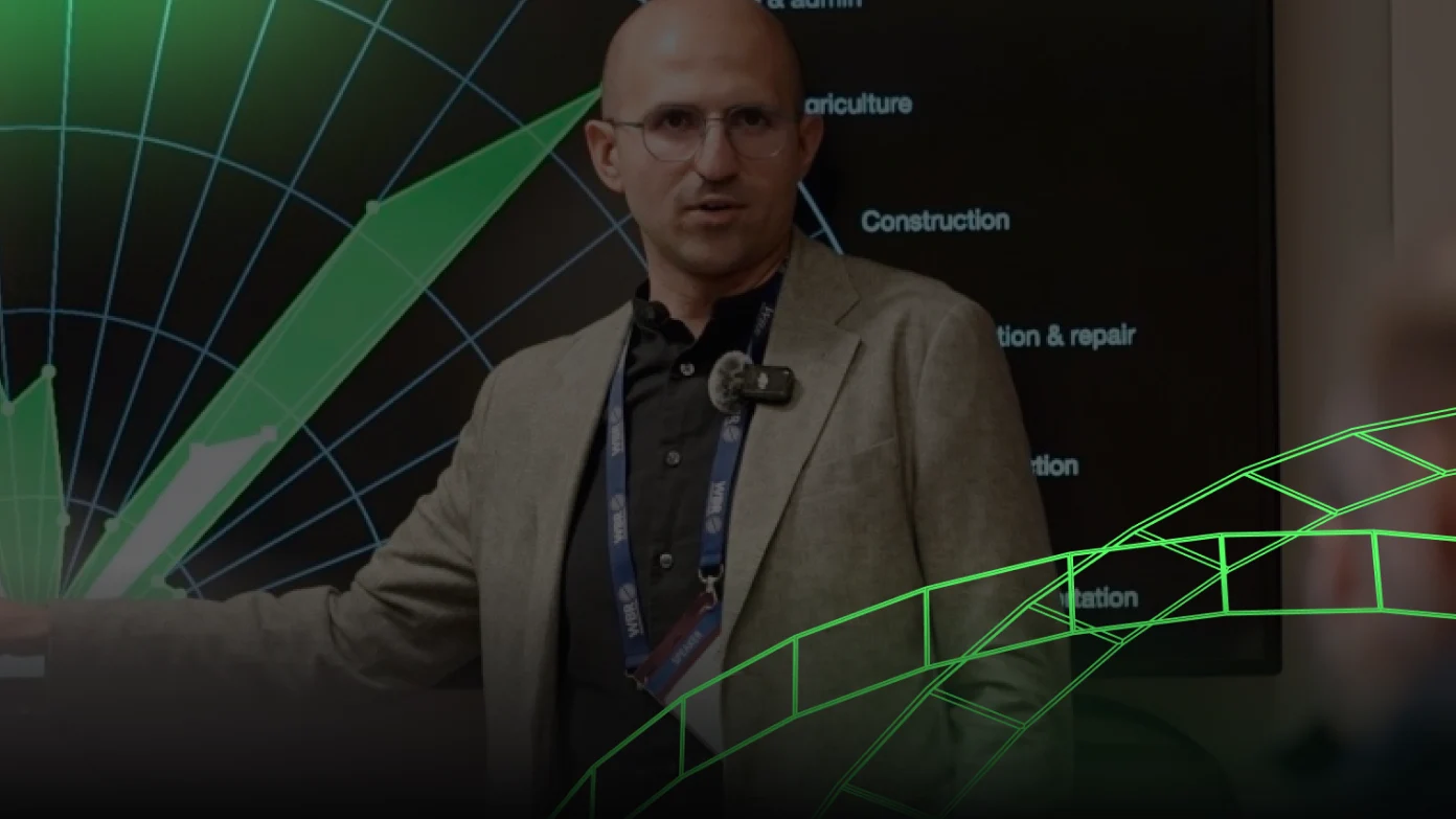 Speaker on stage with green graphic overlay