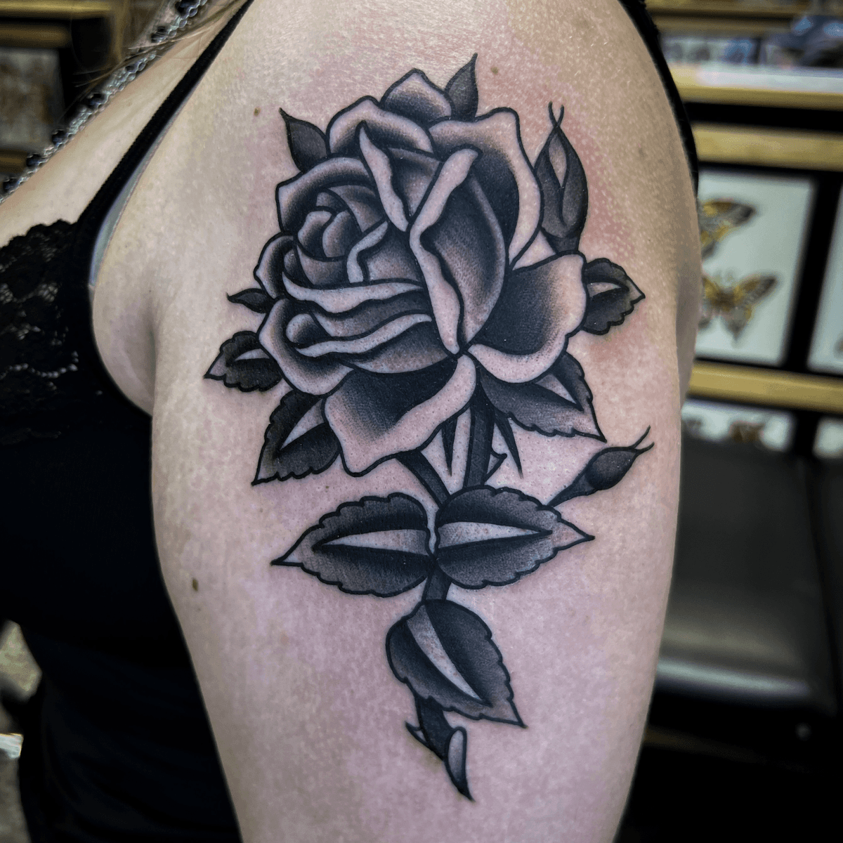 black and gray tattoo of a rose