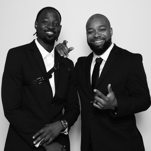 Two friends in front of photobooth. 