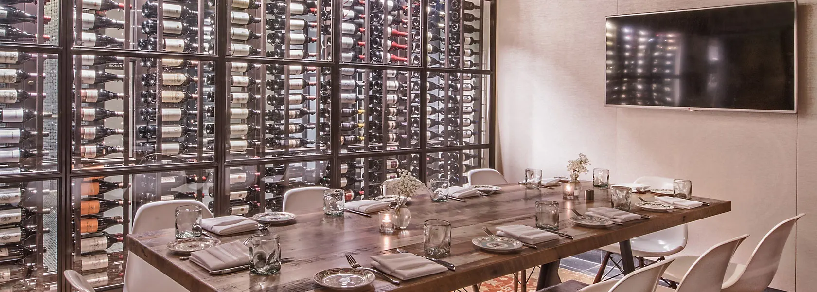 Private dining room table beside a wine wall at The Guild House