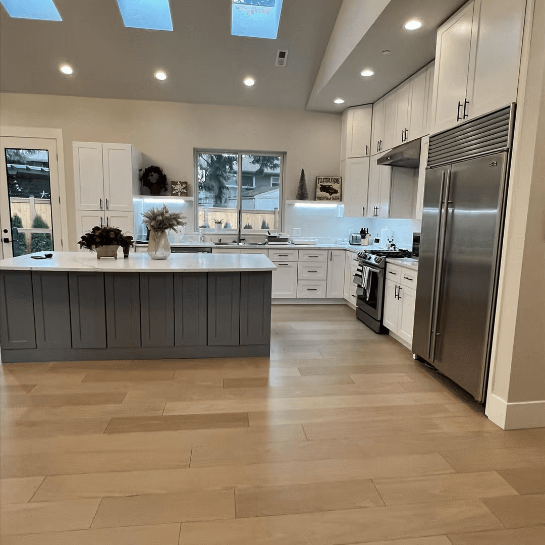 Open, sunlit kitchen in an adult family home designed for shared meals and easy caregiver support.