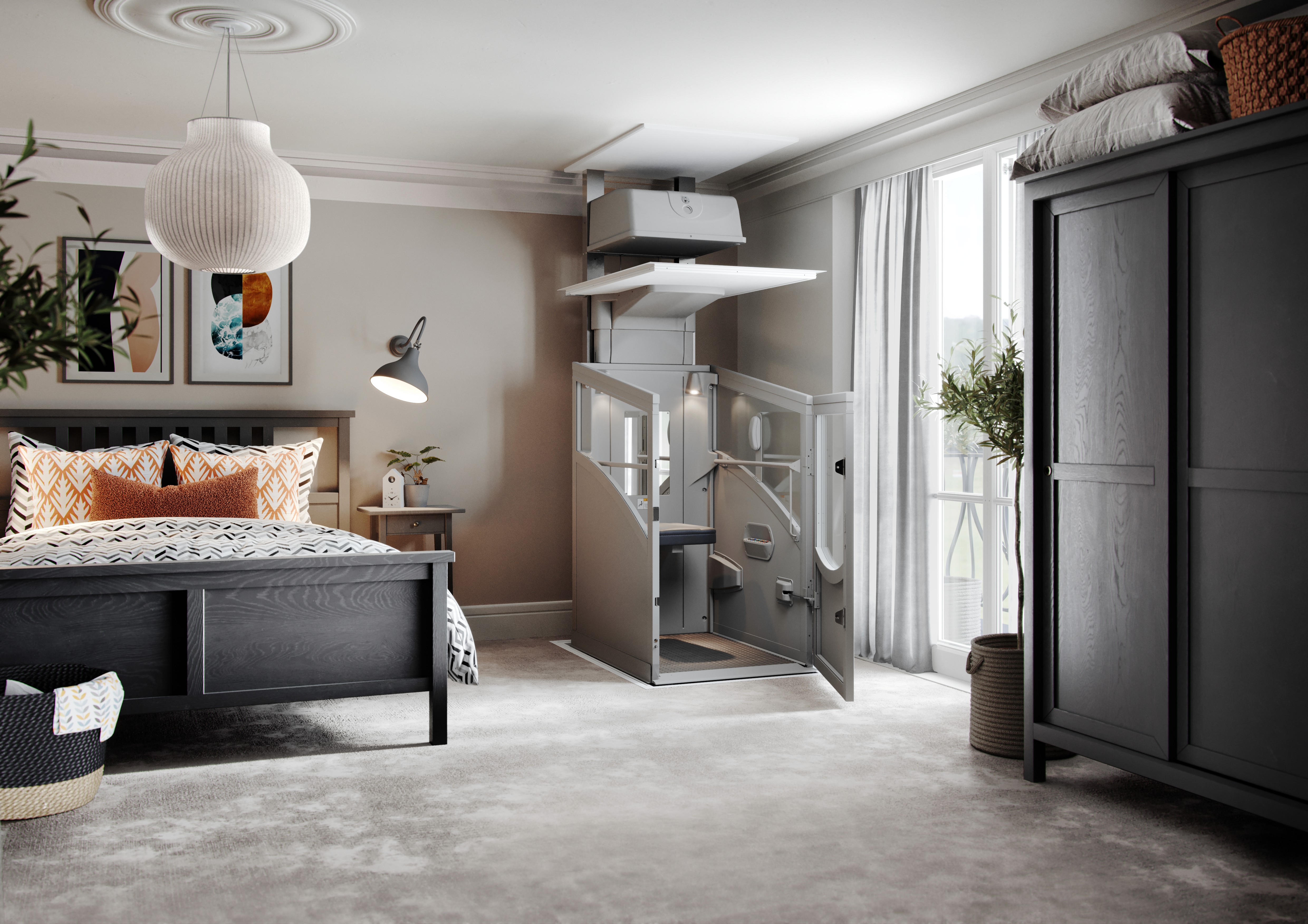 Through-floor home lift with open door installed in a contemporary UK bedroom — grey aluminium cabin with glazed panels rising through the ceiling, shown alongside a dark wood bed with orange cushions, pendant light, and fitted wardrobe