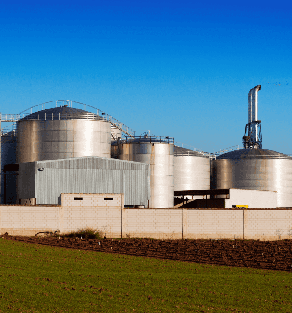 Modern industrial silos and processing facility with clear blue sky