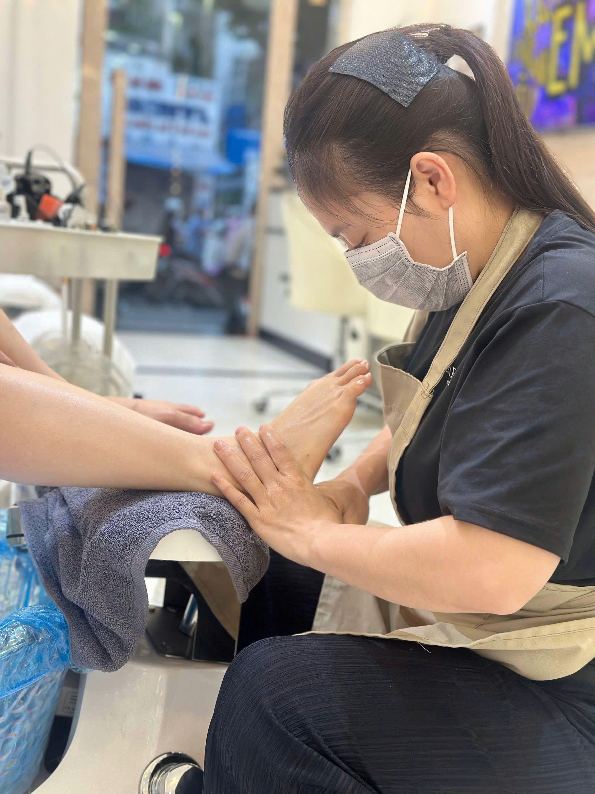 a woman is doing a manicure on a child's hand