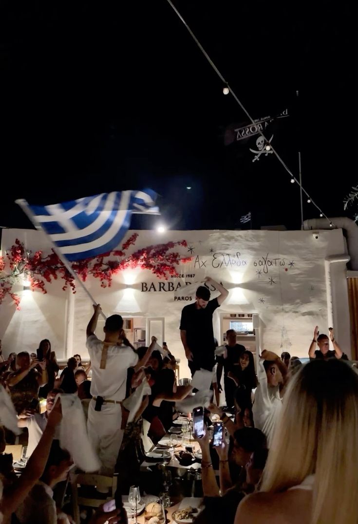 Lively crowd raising their hands toward a stage