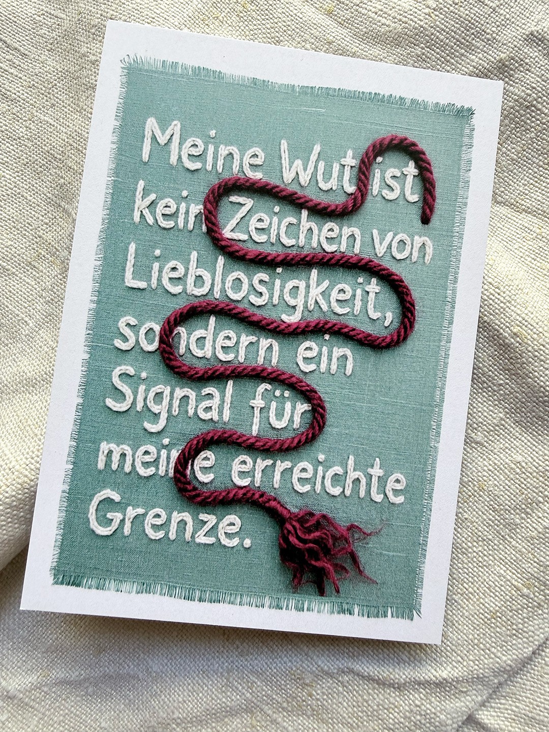 A Card with a embroidered Text