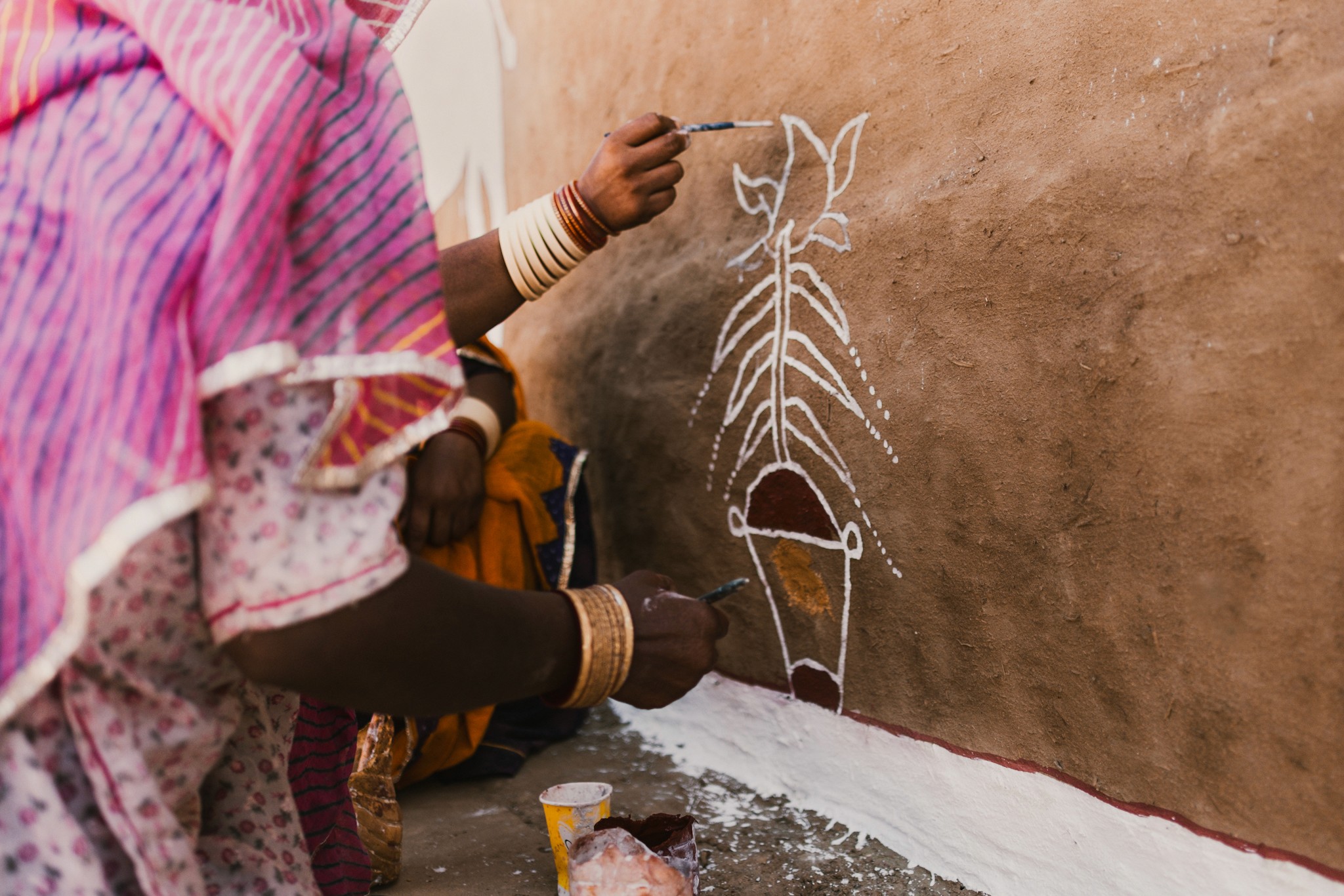 Women painting the Kuldhara village near Jaisalmer, Rajasthan