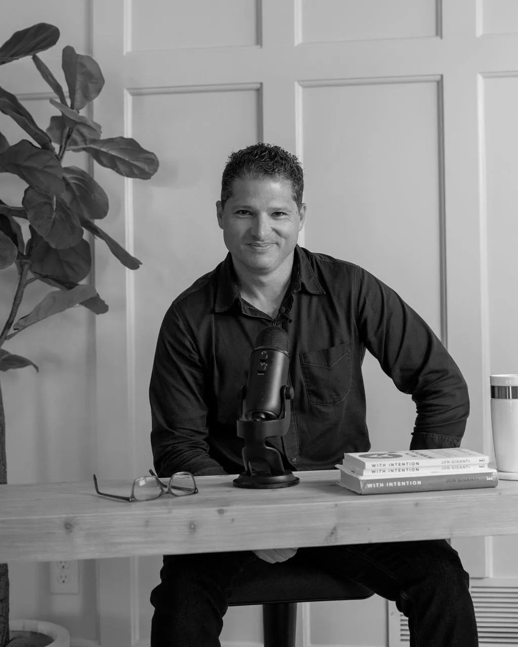 jon smiling in front of a microphone