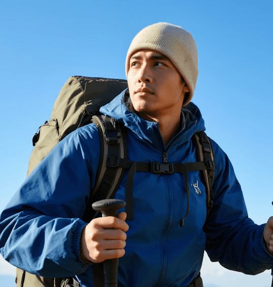 Man in a blue suit climing on mountain