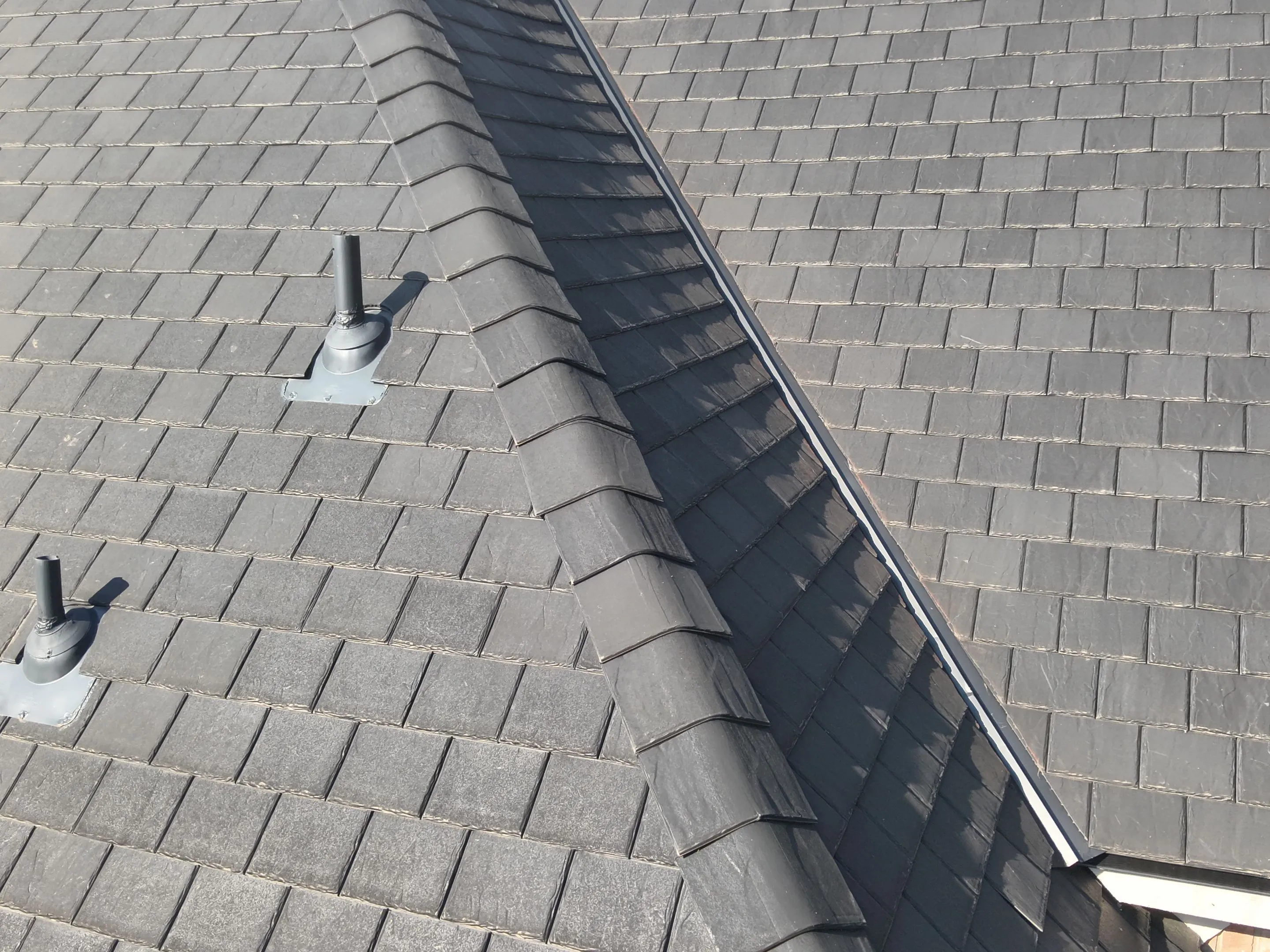 Roof vent penetration detail on F-Wave synthetic roof installation in Corinth Texas showing weatherproof sealing