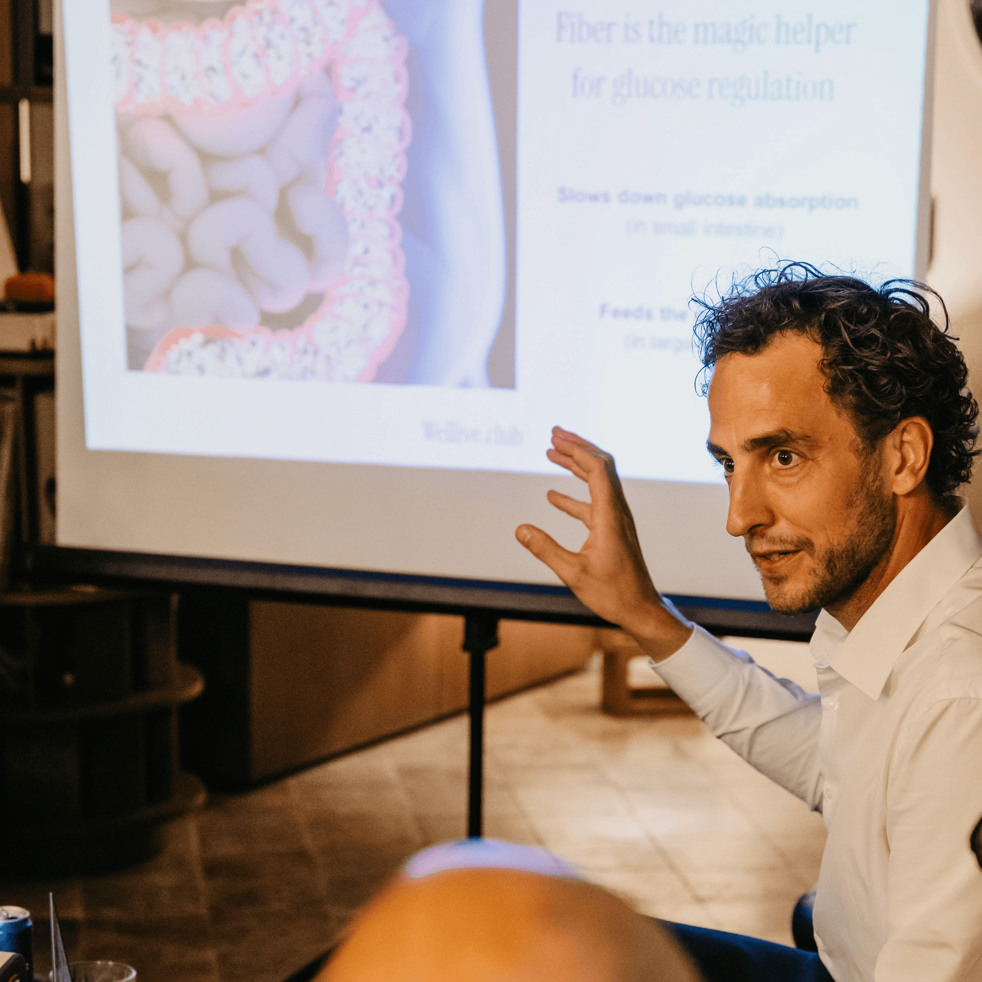 A serene spa setting with two lounge chairs beside a warm, reflective pool and soft, natural lighting.