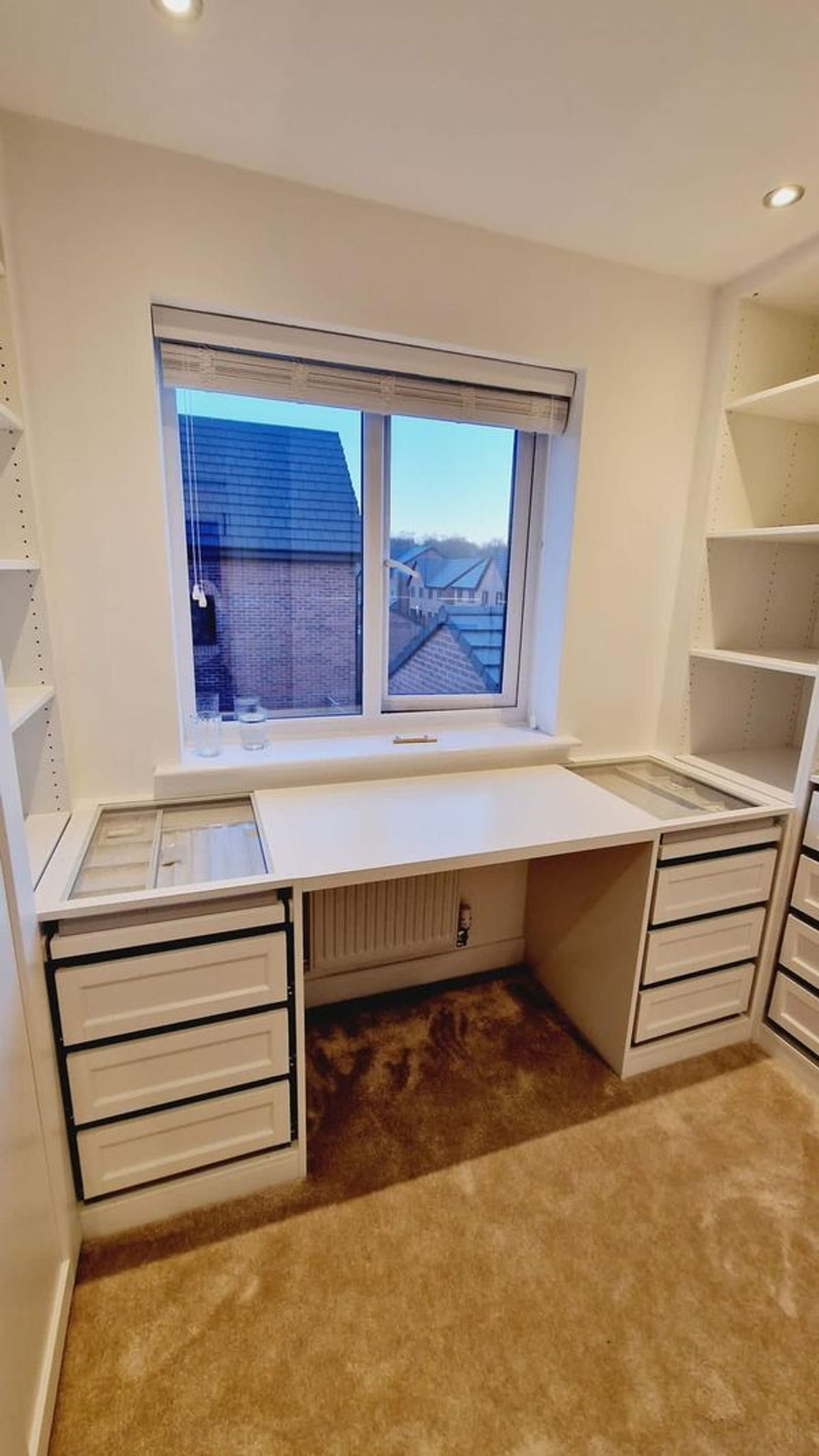 a dressing make-up table placed under a window