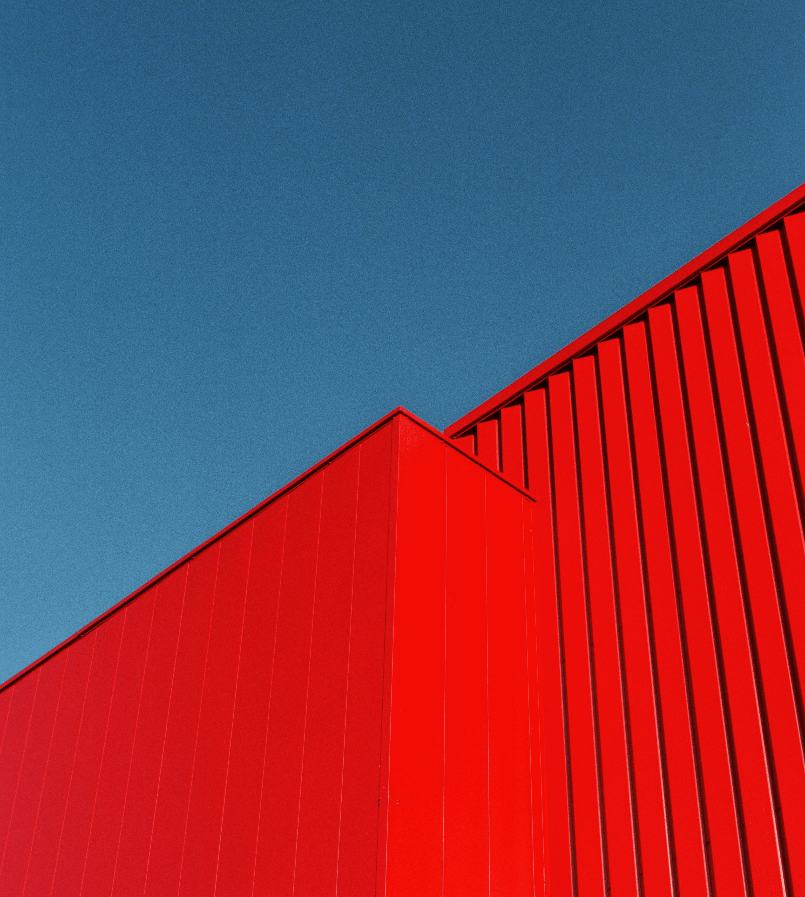 a red building with a blue sky in the background