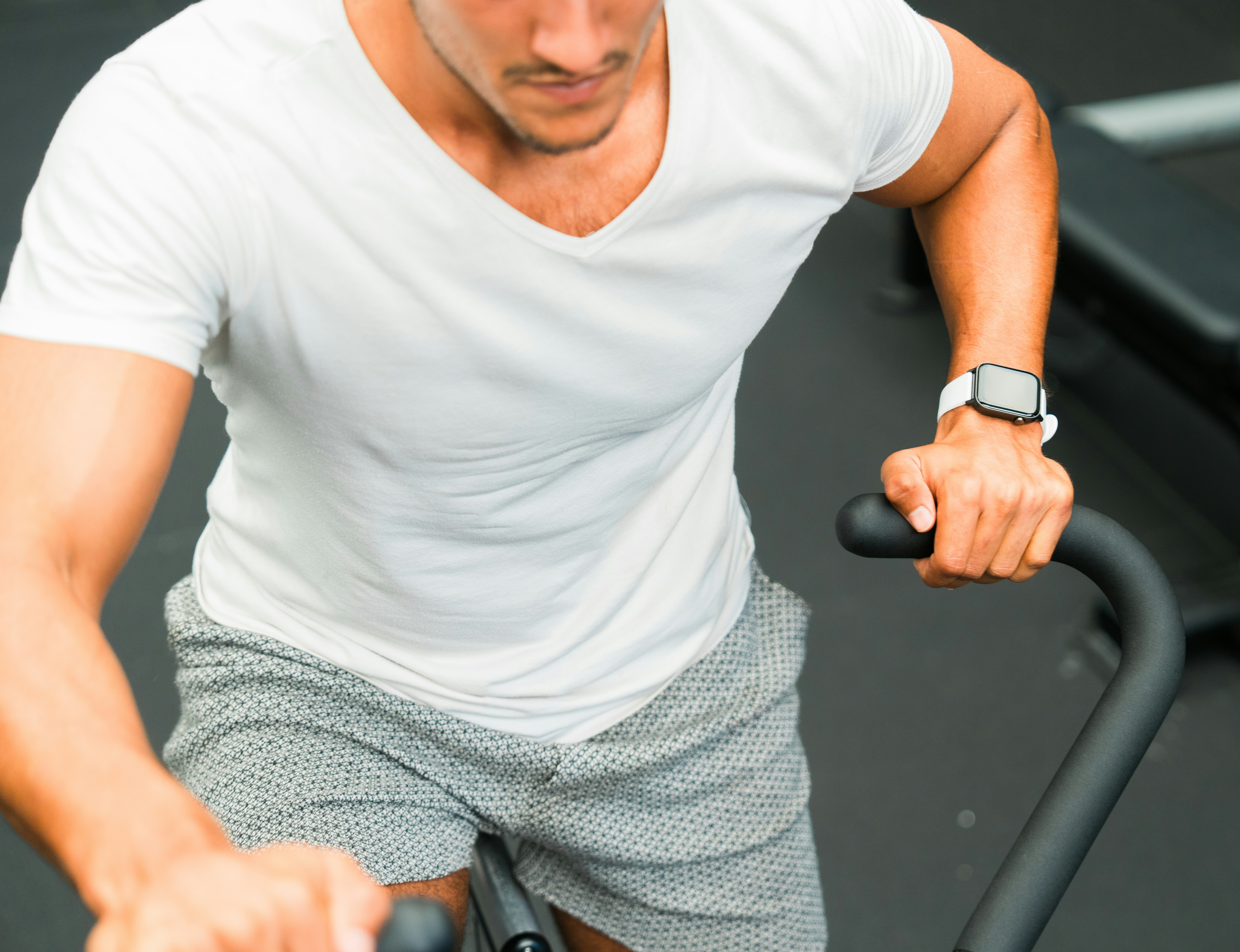 A man on a stationary bike in a gym