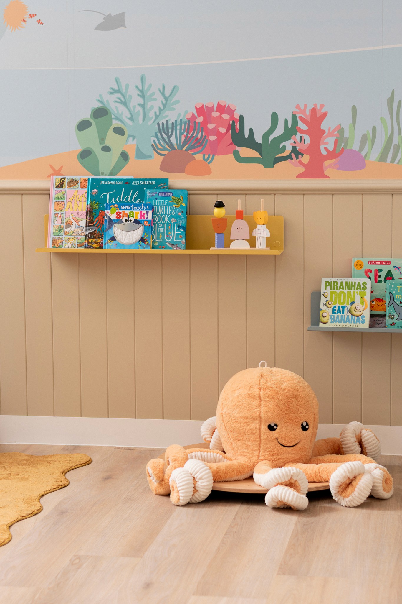 Close-up of a dark green leaf showing its textured surface and central vein against a muted background.