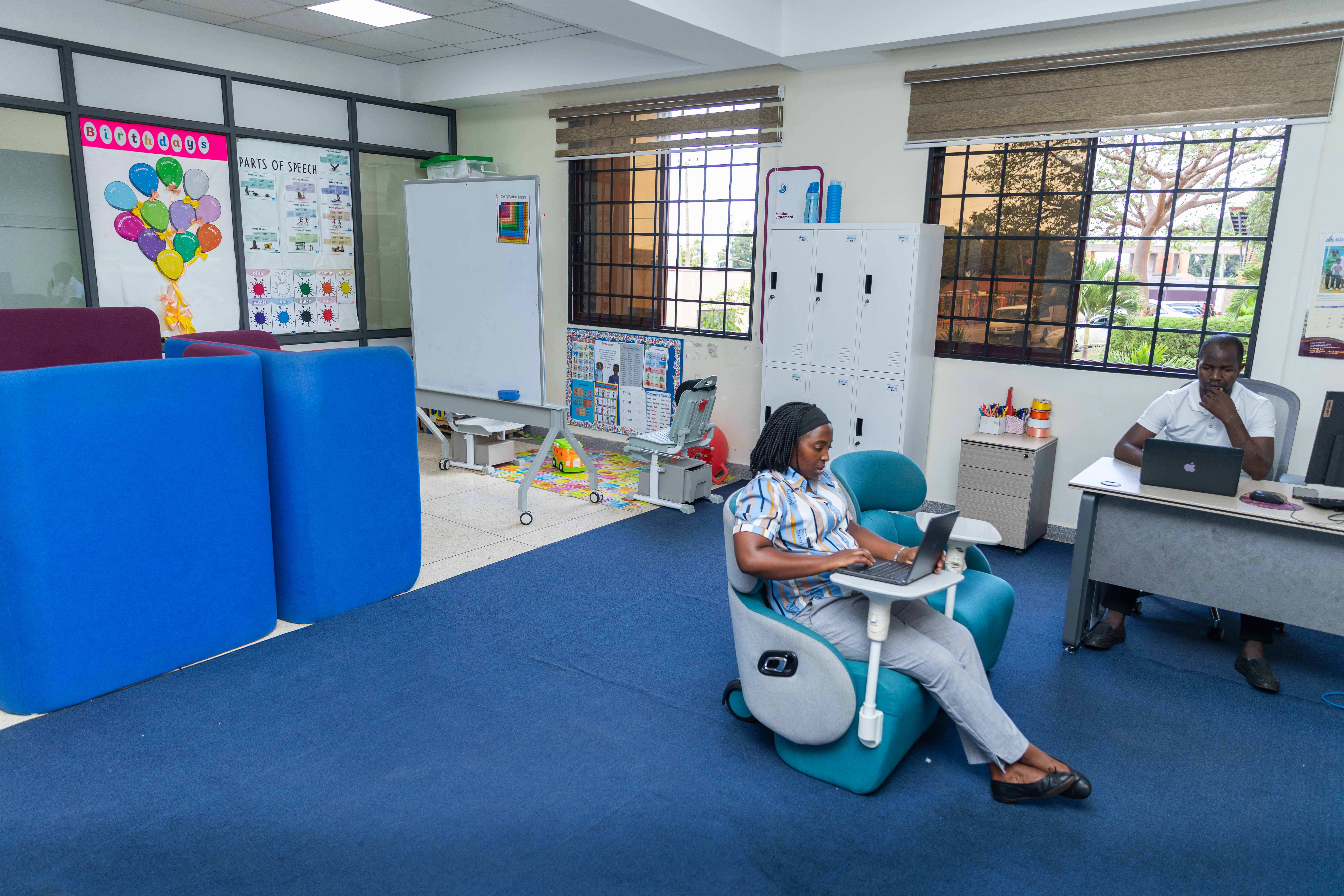 A mother and her daughter are working together on a laptop, focusing on homework