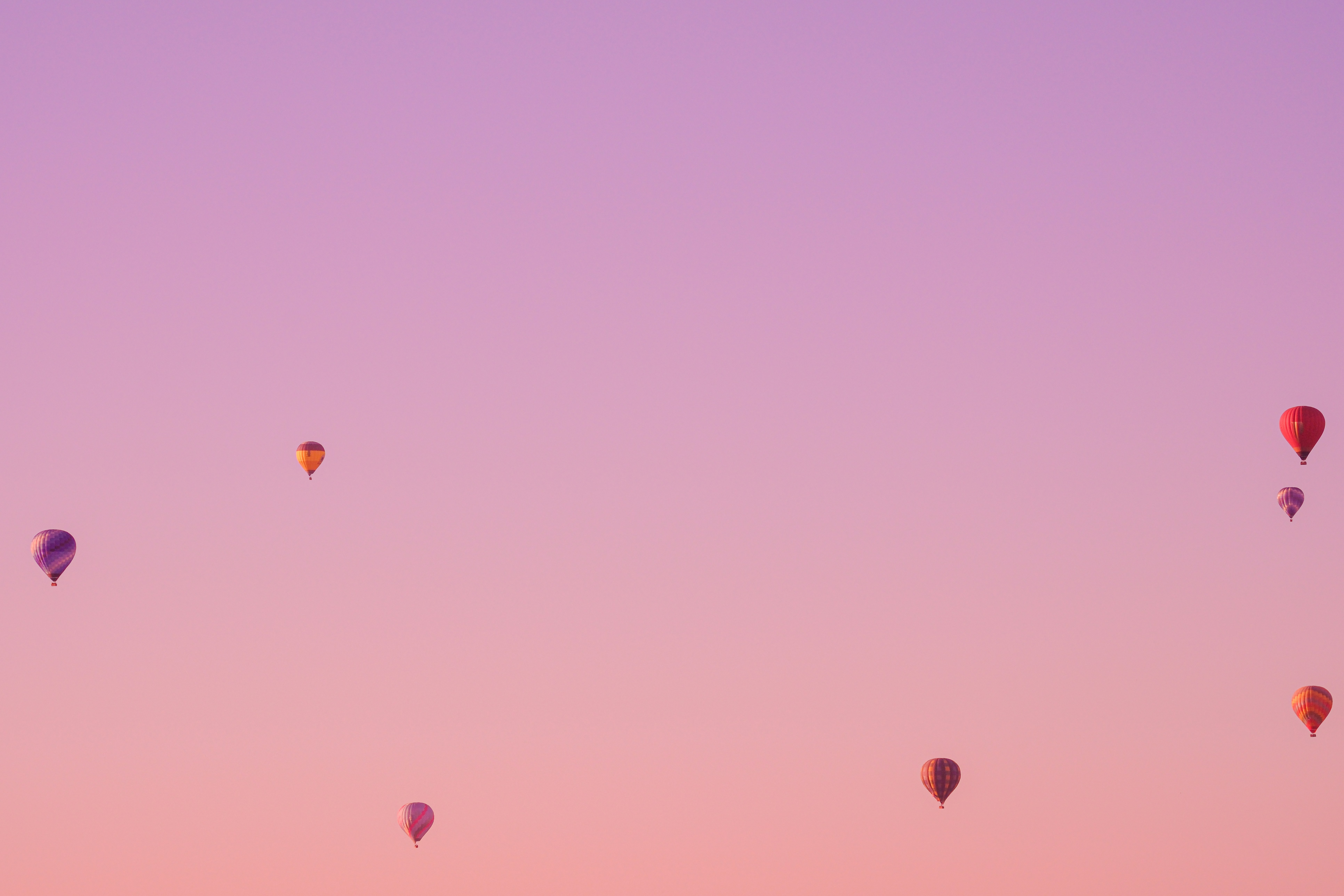 a group of hot air balloons flying in the sky