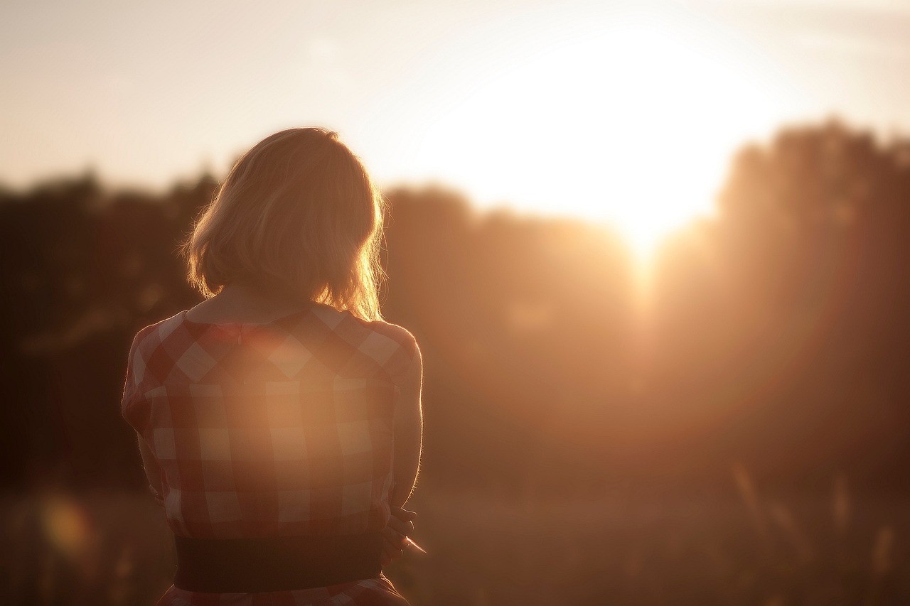 A woman in the woods sitting by herself in isolation, heso blog image