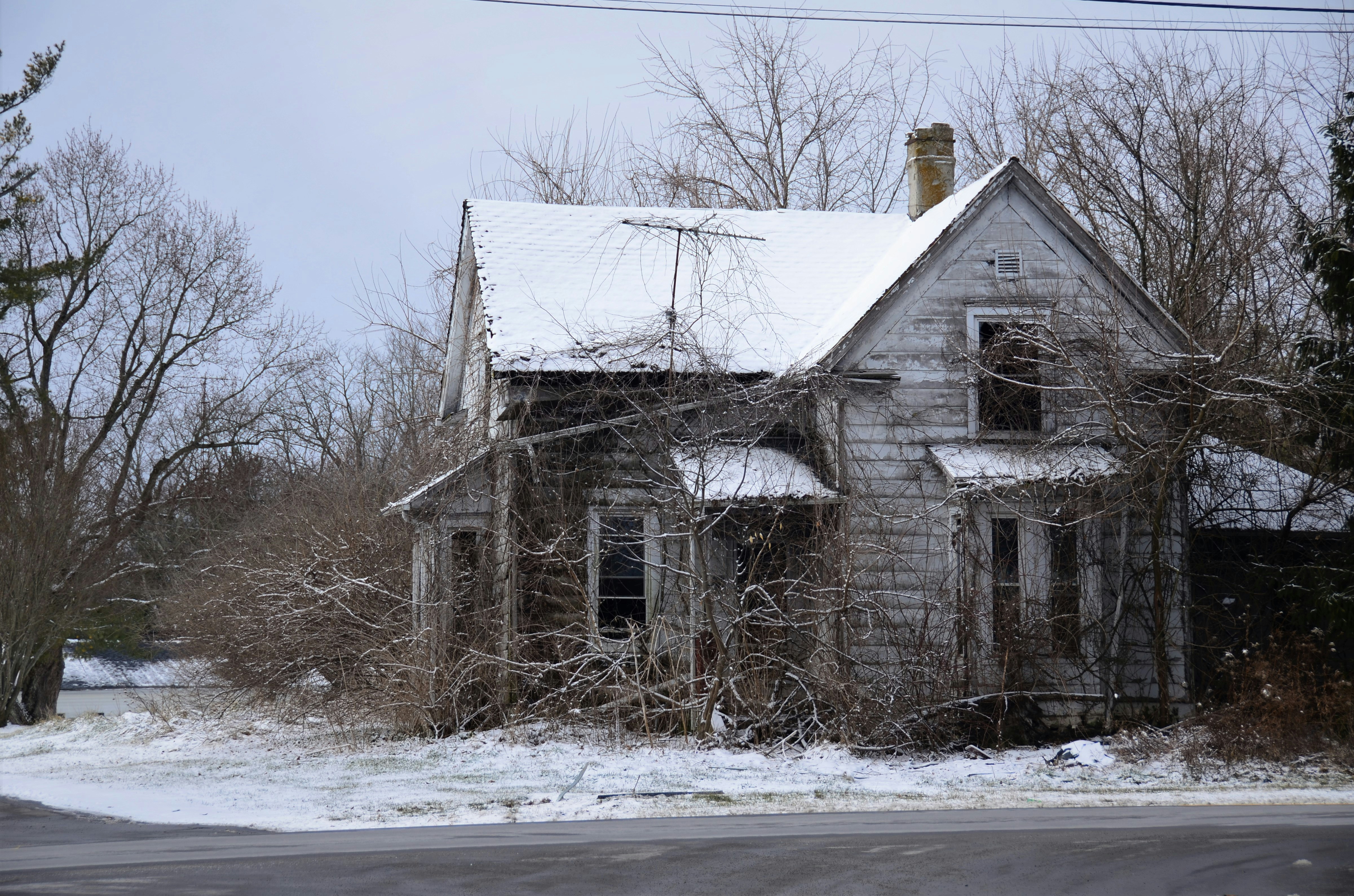 brown wooden house on snow covered ground