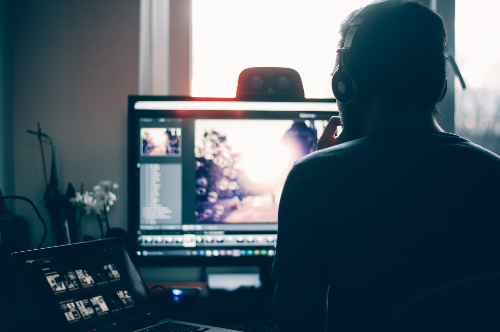Guy with earphones editing video