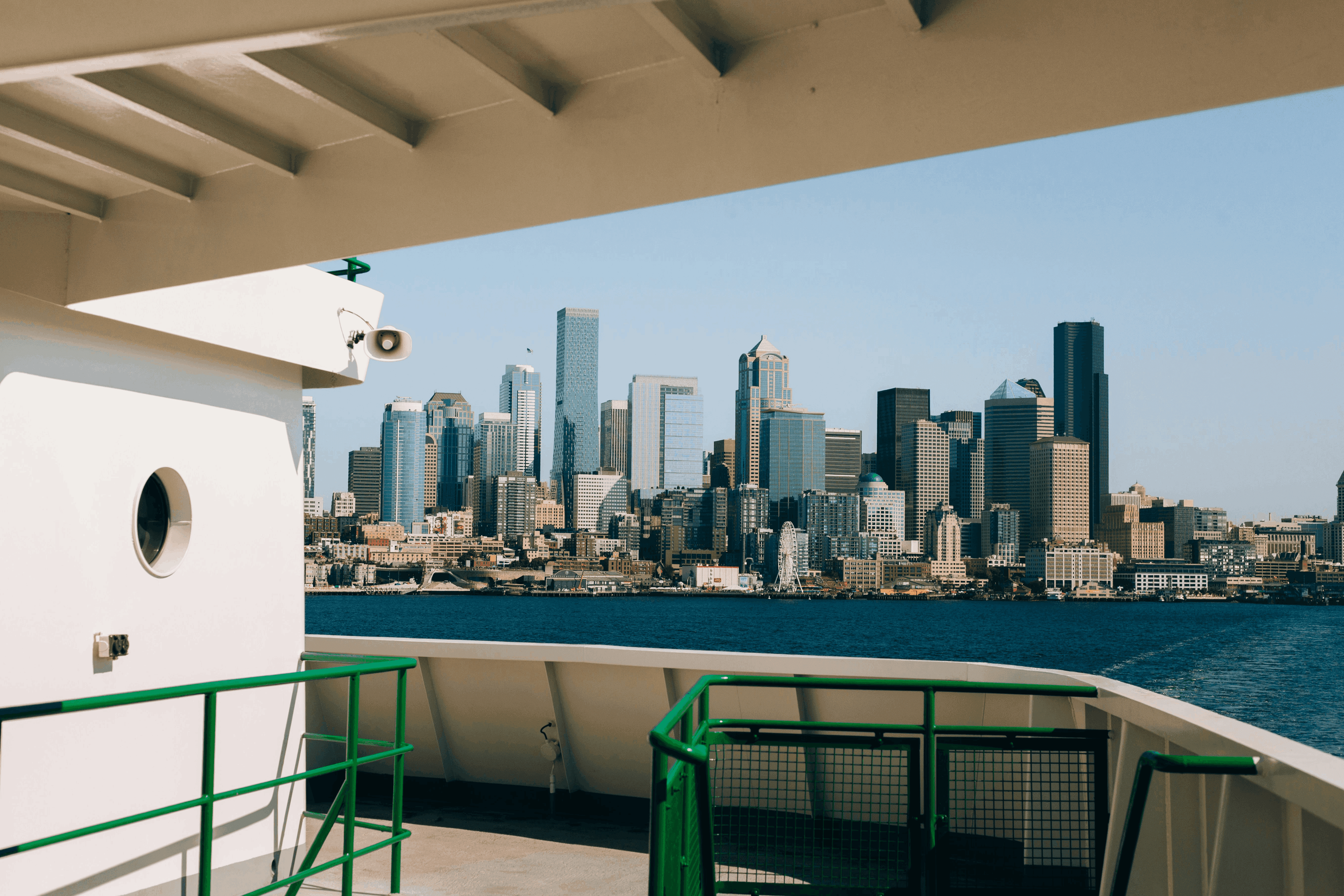 City skyline across the water from a ferry deck.