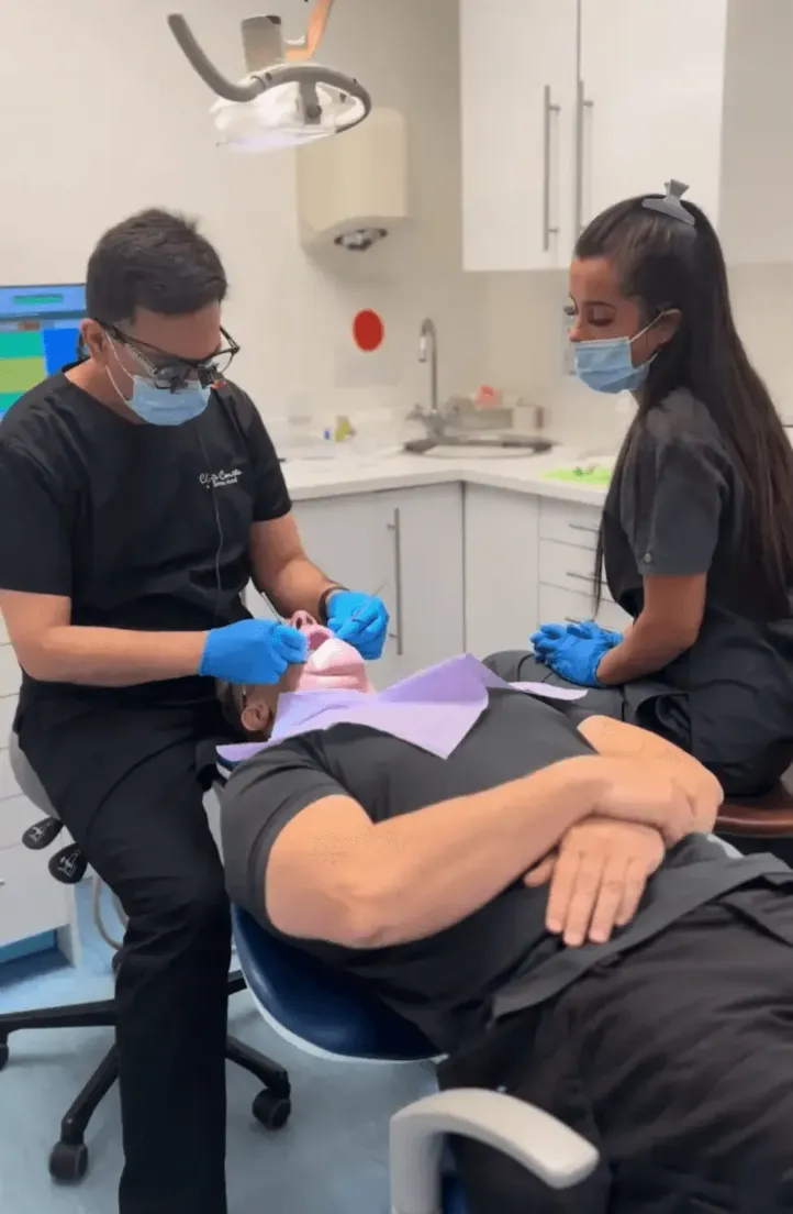 Dr Khalid and Sophie, in surgery, giving treatment to a patient