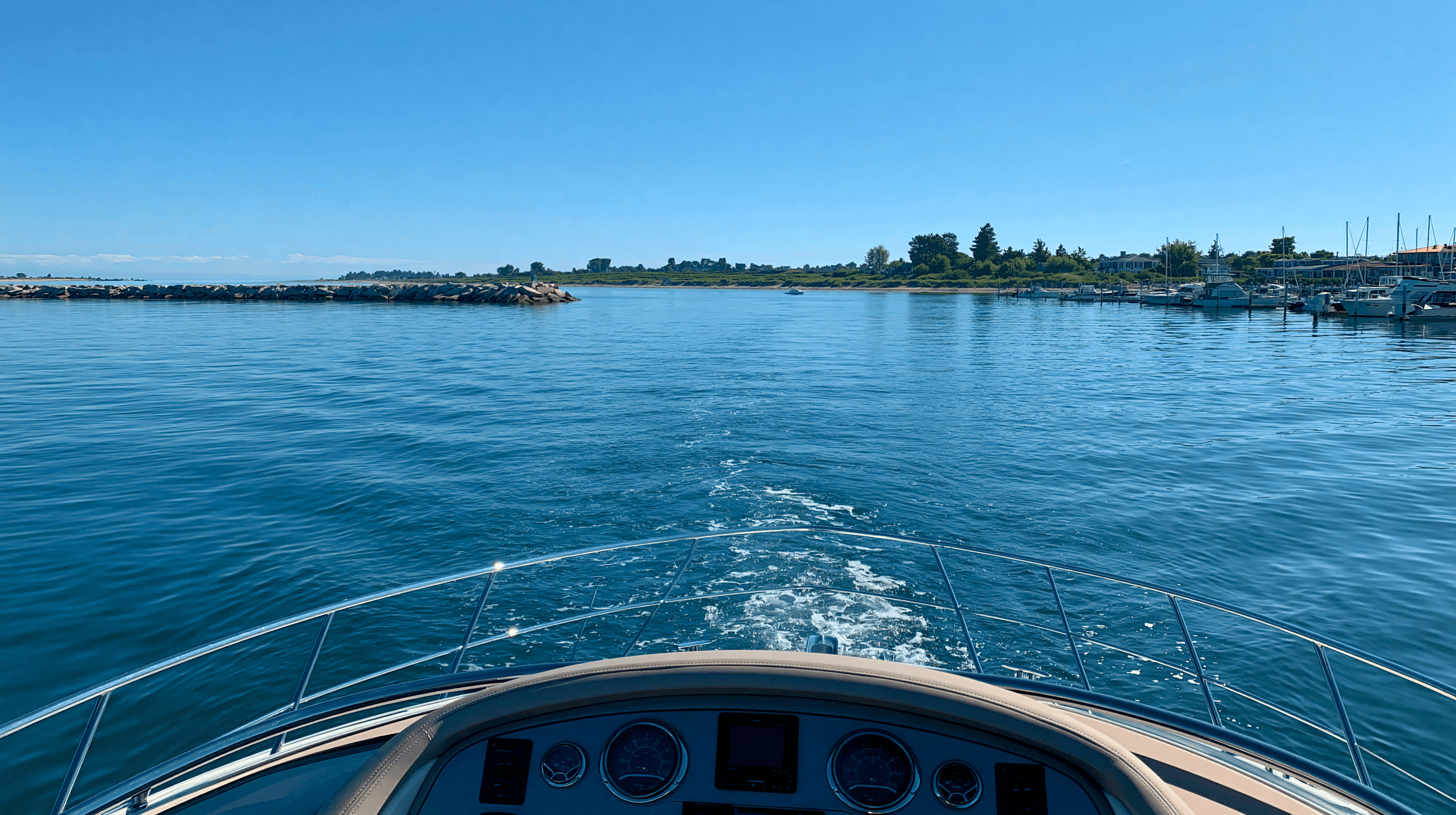 A yacht navigating through ports with boats