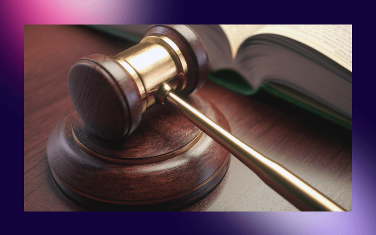 Gavel resting on a sounding block with an open book in the background, symbolizing judgement and intercession concepts in a legal or religious context.