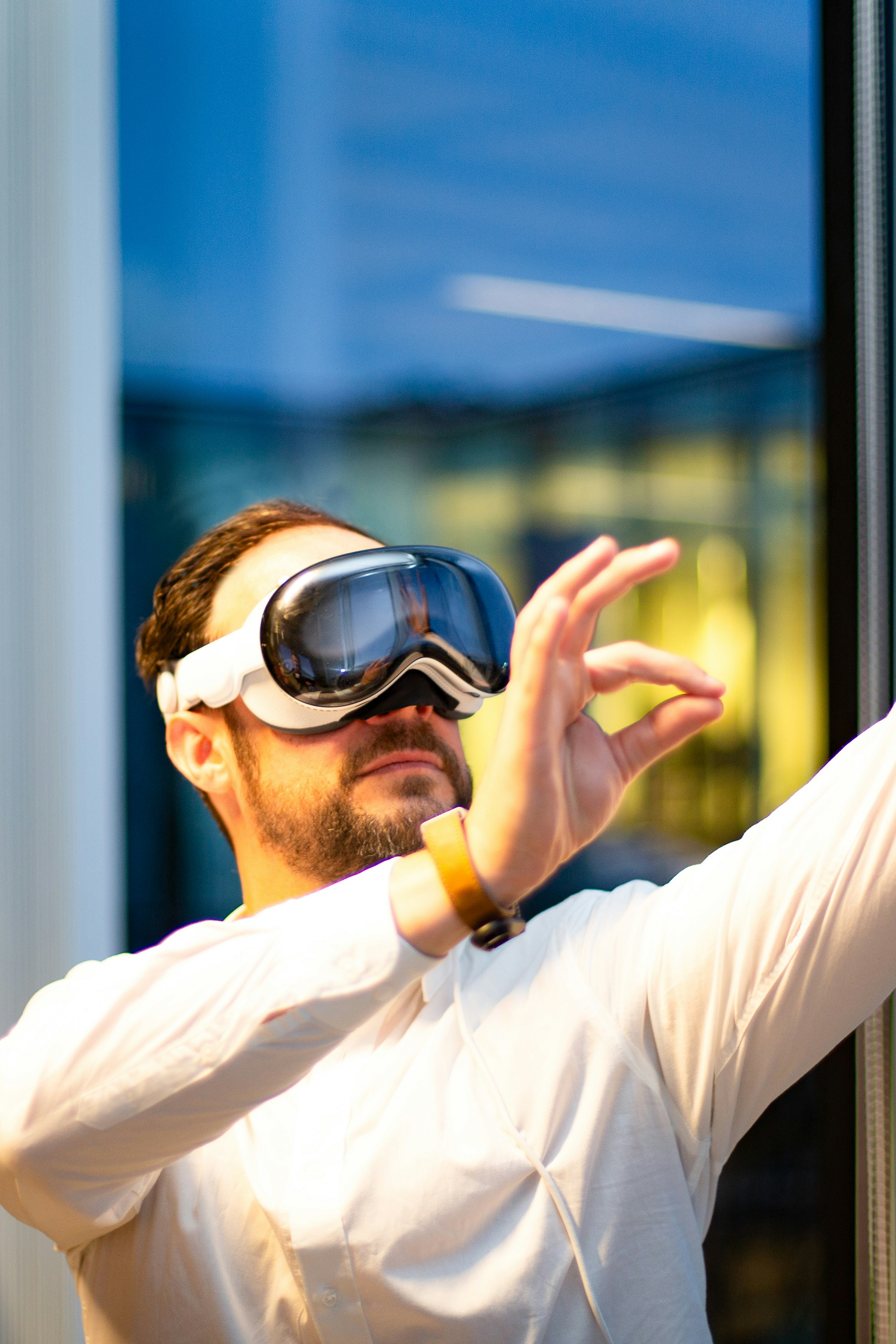 This image shows a man trying out the Apple Vision Pro headset