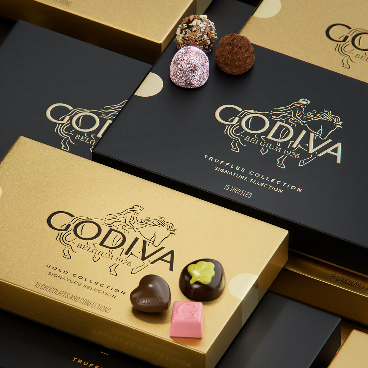 Godiva chocolate boxes with assorted truffles and confections arranged in a refined luxury packaging display.