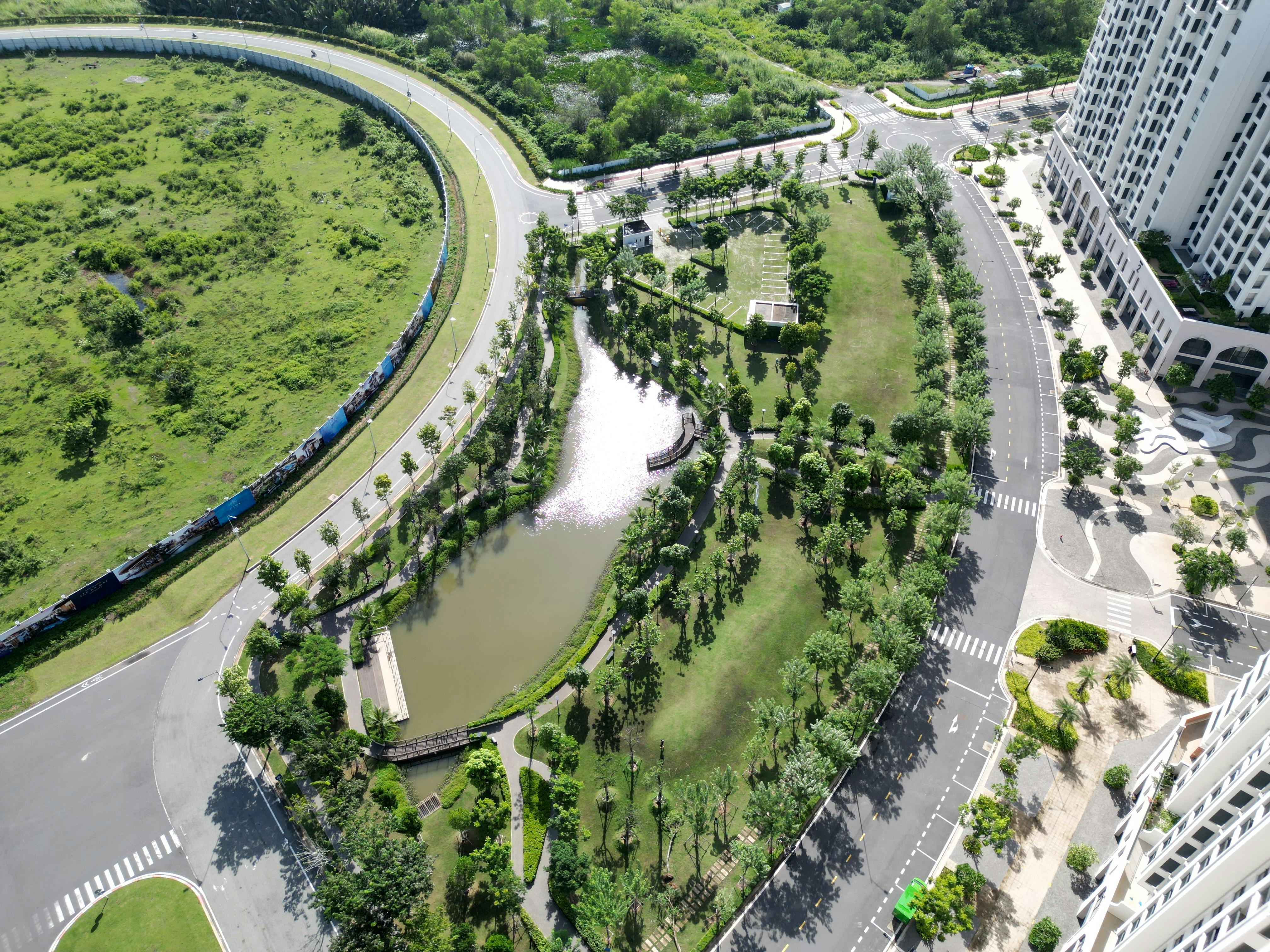 Top-down view of wind turbine over dry terrain with adjacent building