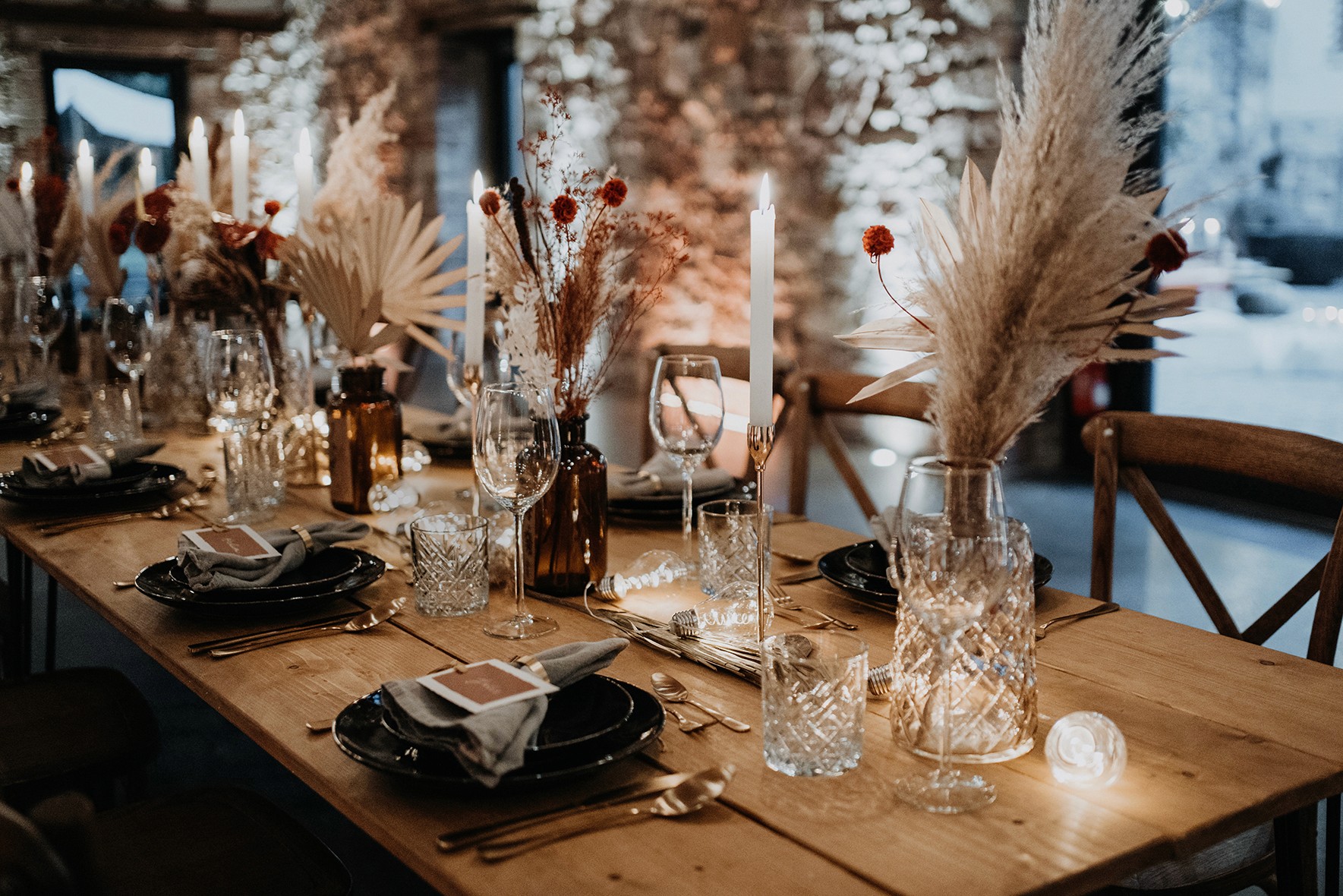 Person balancing on rocks by the ocean at sunset