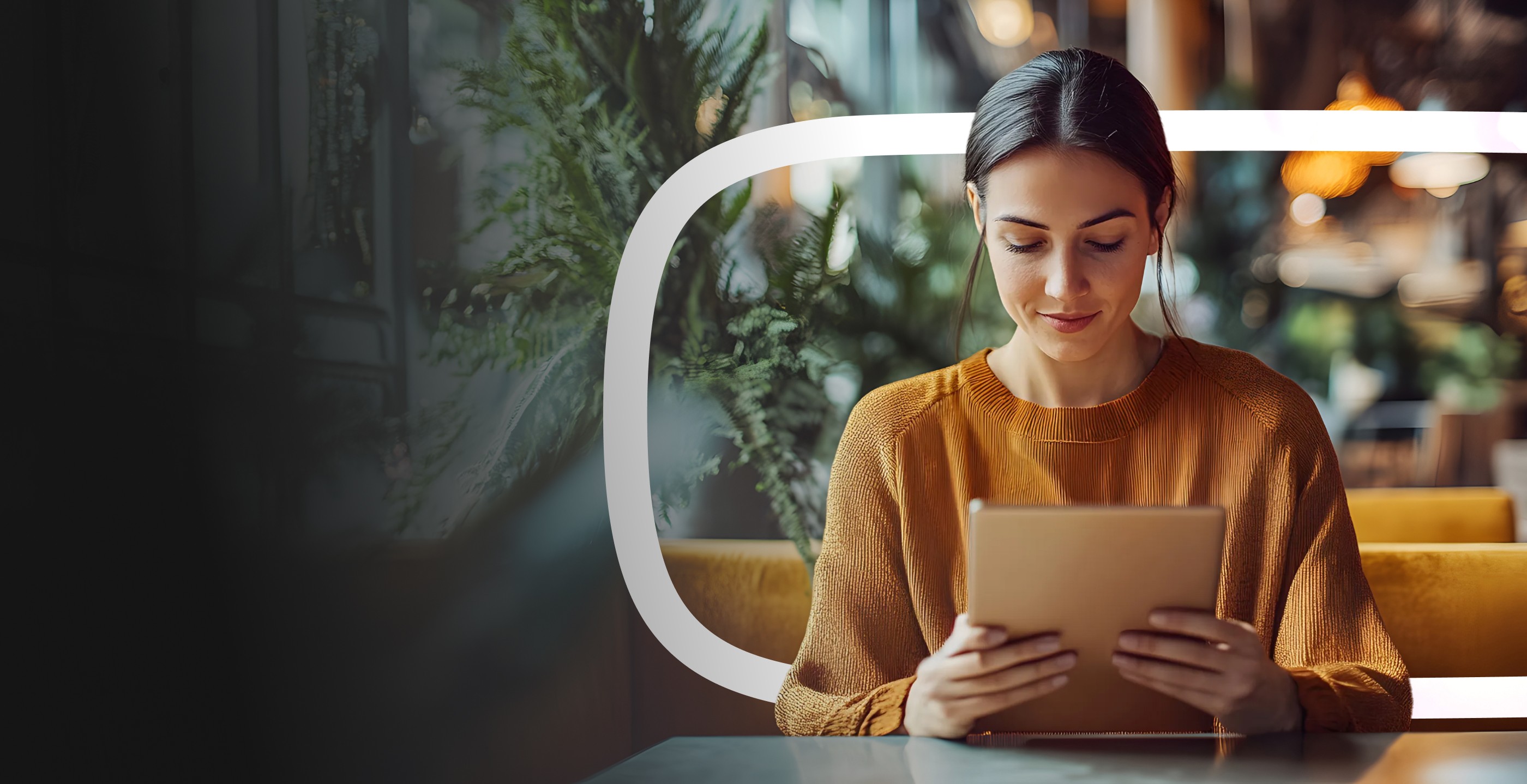 Dirigeante de PME consultant sa tablette dans un espace de travail moderne