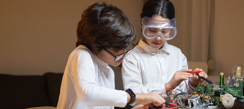Students exploring science, technology, engineering, arts and math in hands-on STEAM after school program