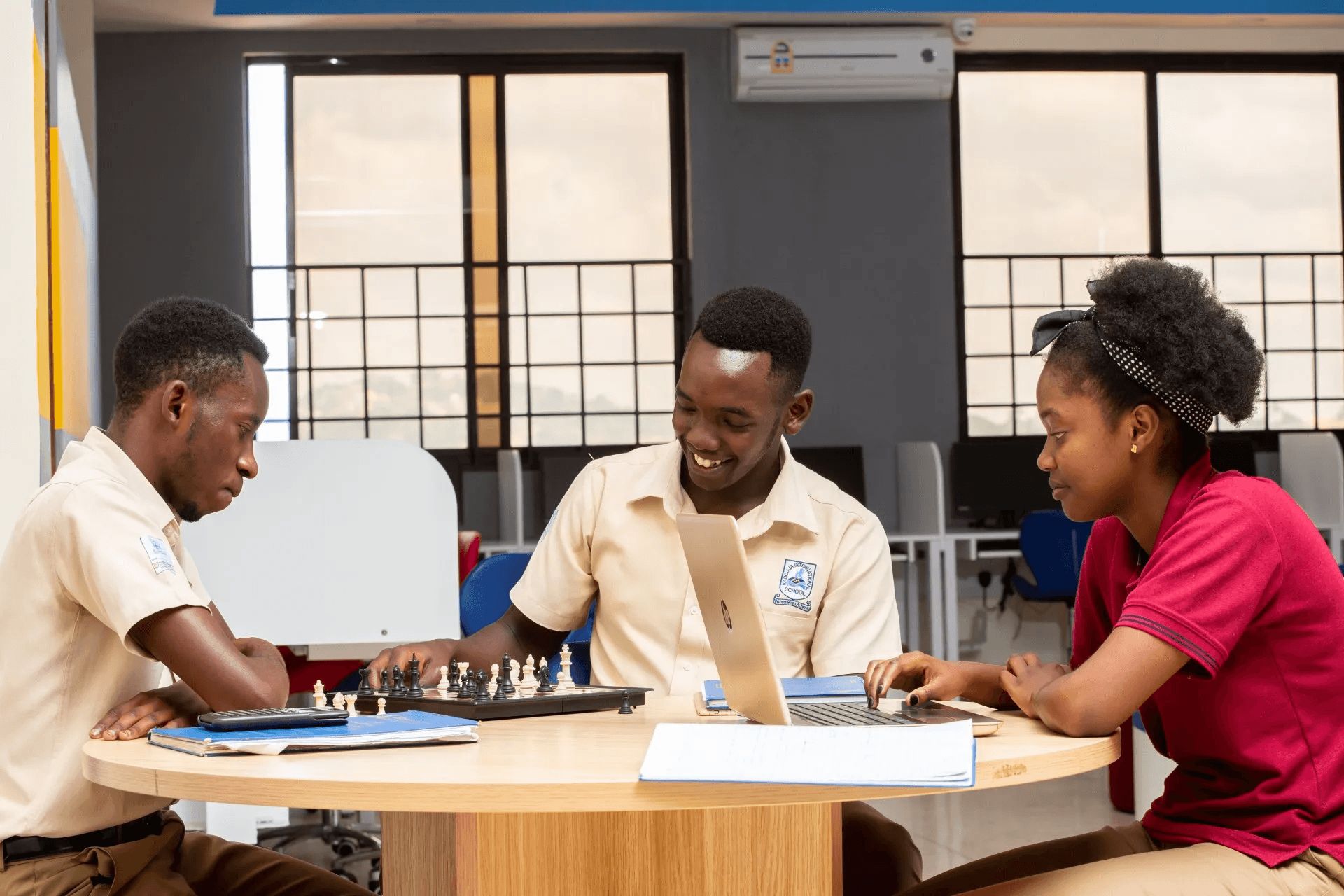 A student is writing in a notebook, concentrating on her work