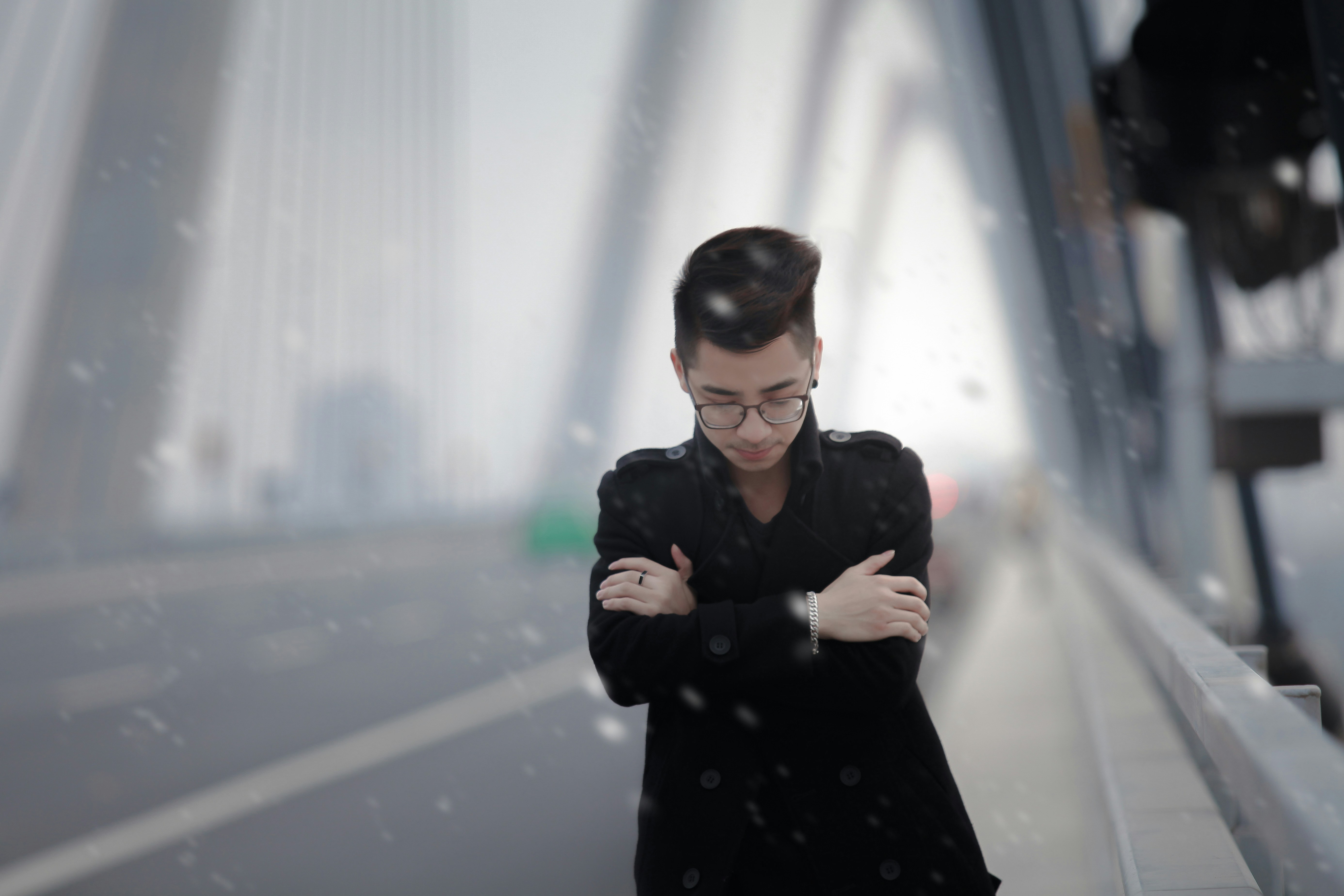 man in black coat standing on snow covered ground during daytime