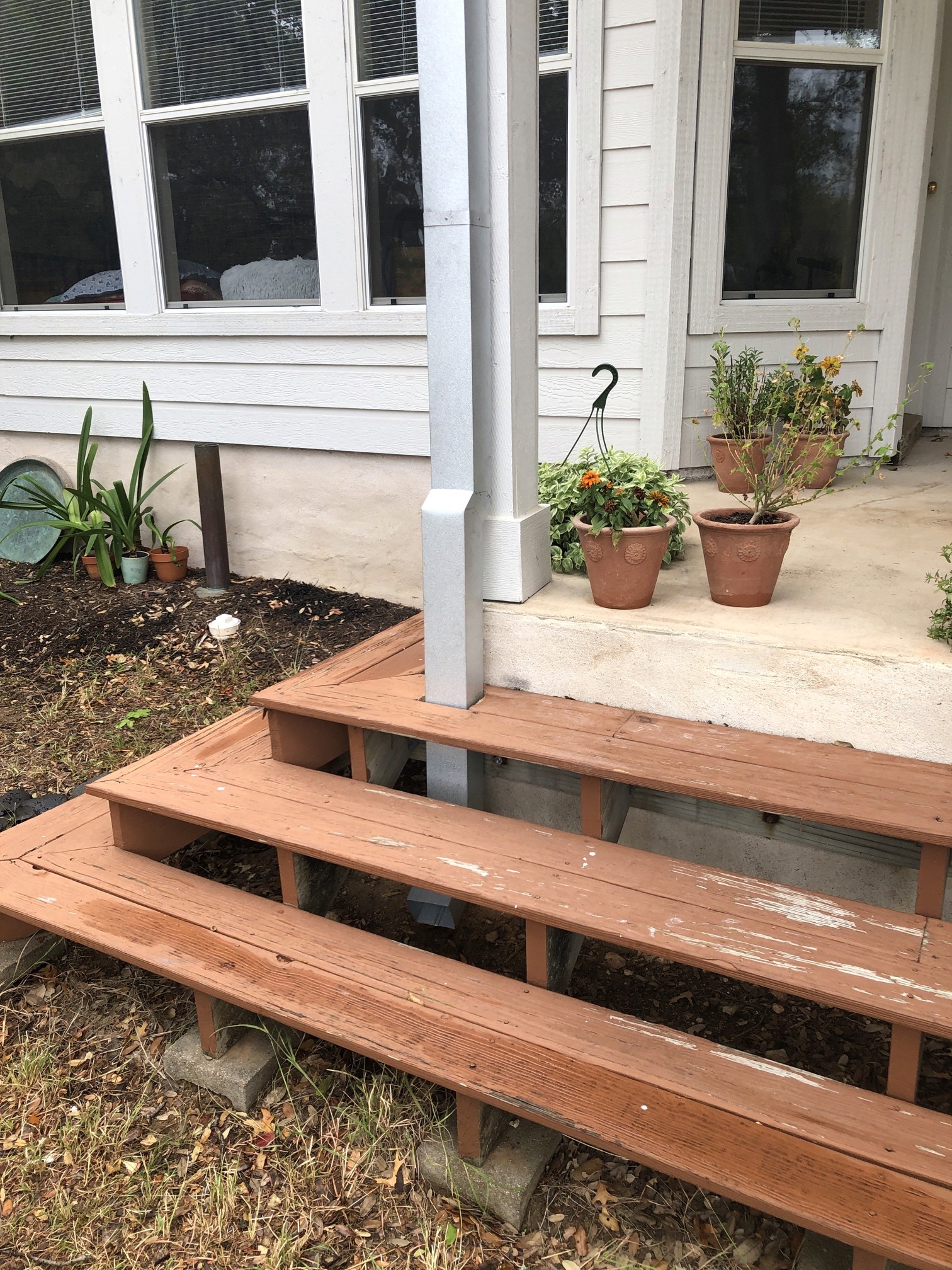 Square galvalume gutters to match the standing seam roof that lead under the porch to drain water. 