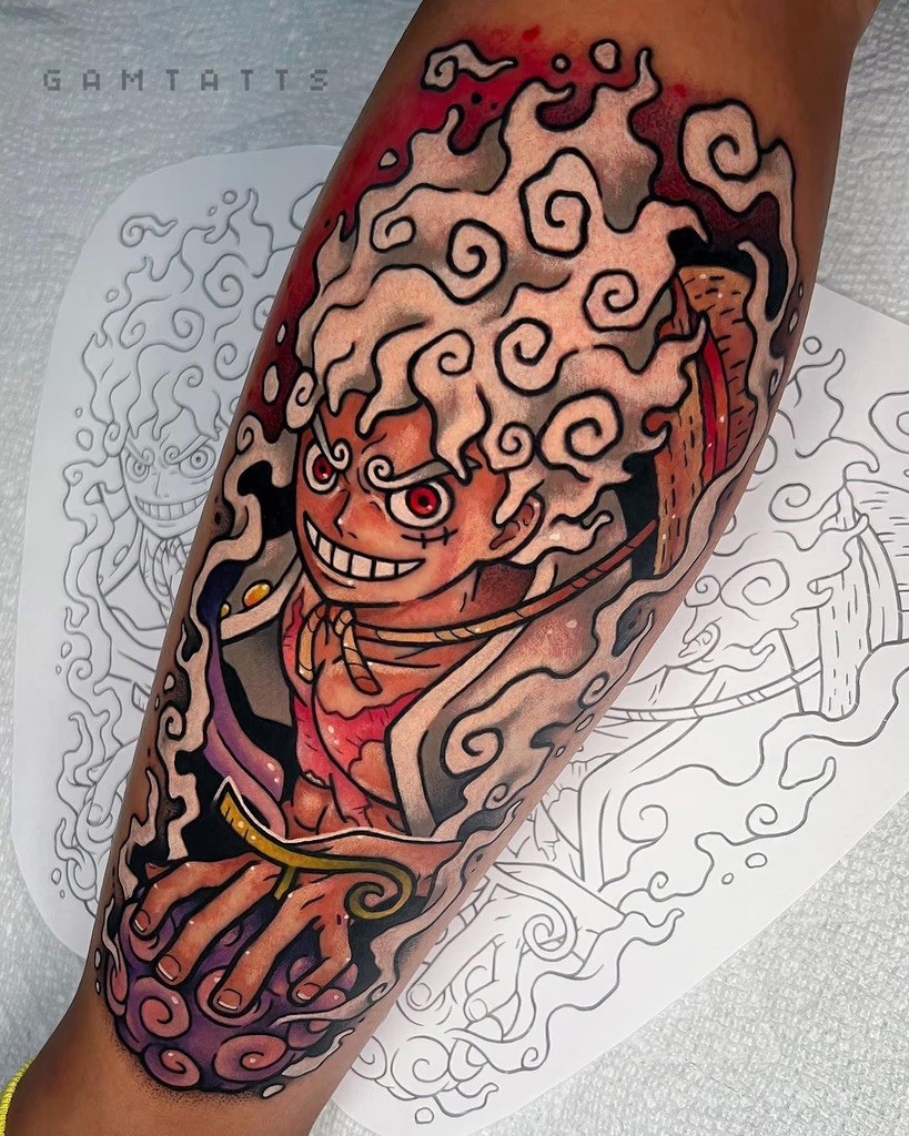 A colorful depiction of Luffy in his Gear 5 form, with a mischievous grin and wild white hair. The swirling cloud effects and bright red eyes capture the chaotic energy of this form, with expertly layered shading and vibrant hues making this tattoo pop.