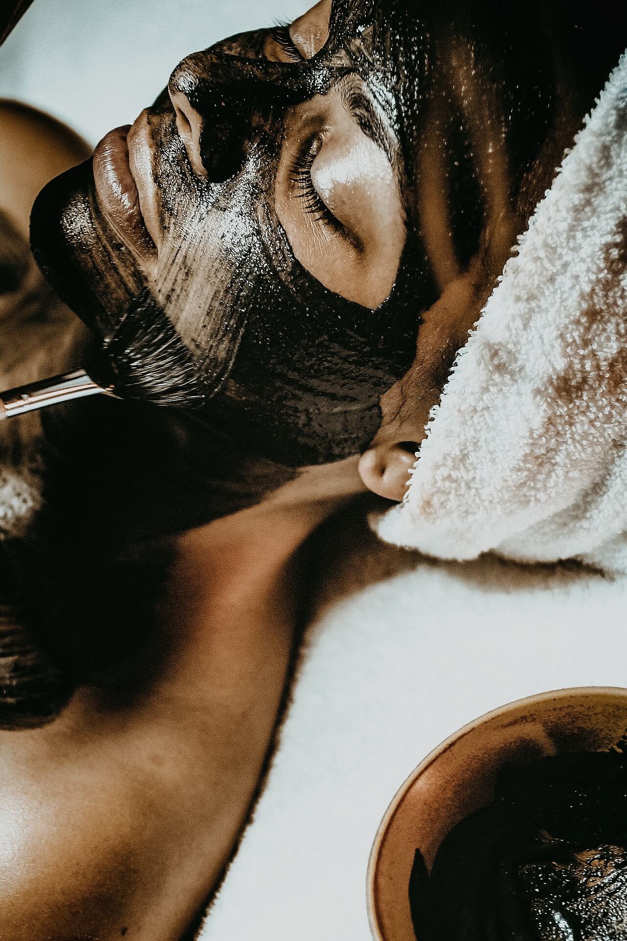 Client receiving a black mask facial treatment at Sam Hoult Beauty, a professional beauty salon in Hull offering personalized beauty treatments.