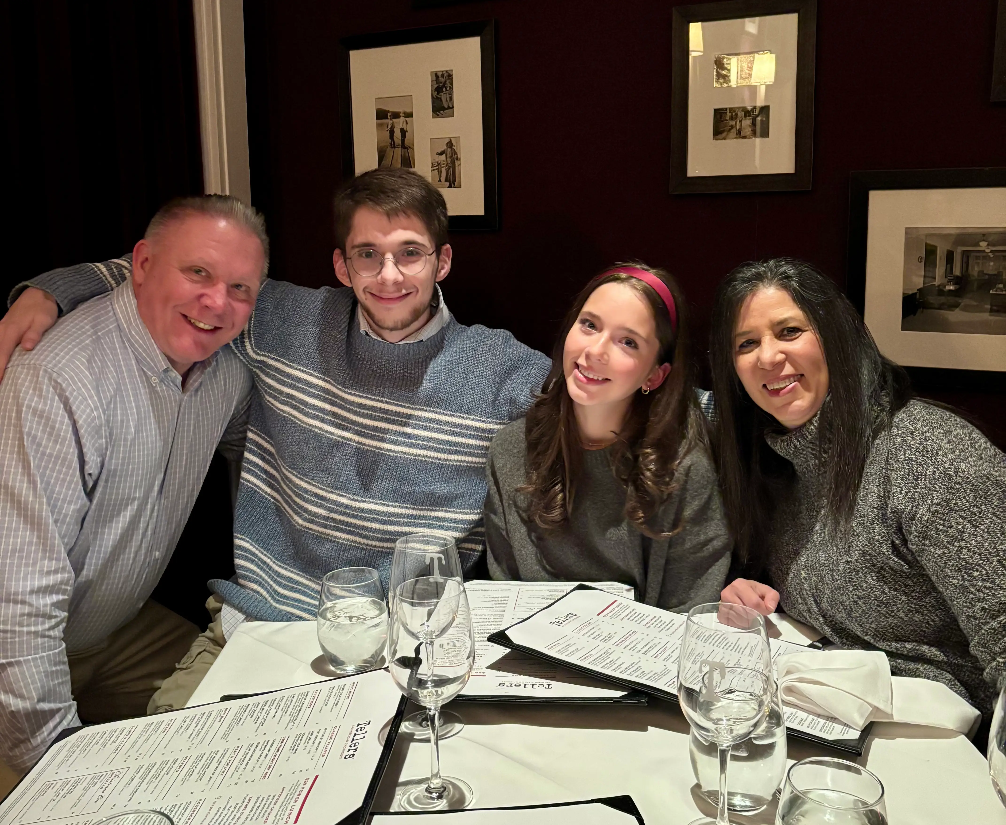 group of people, seemingly a family sitting around a table at a restaurant