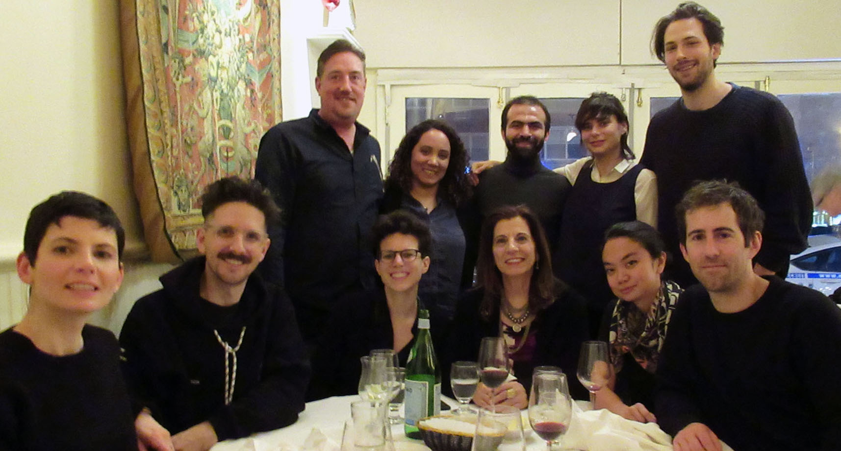 A photo of a group of people sitting at a table.