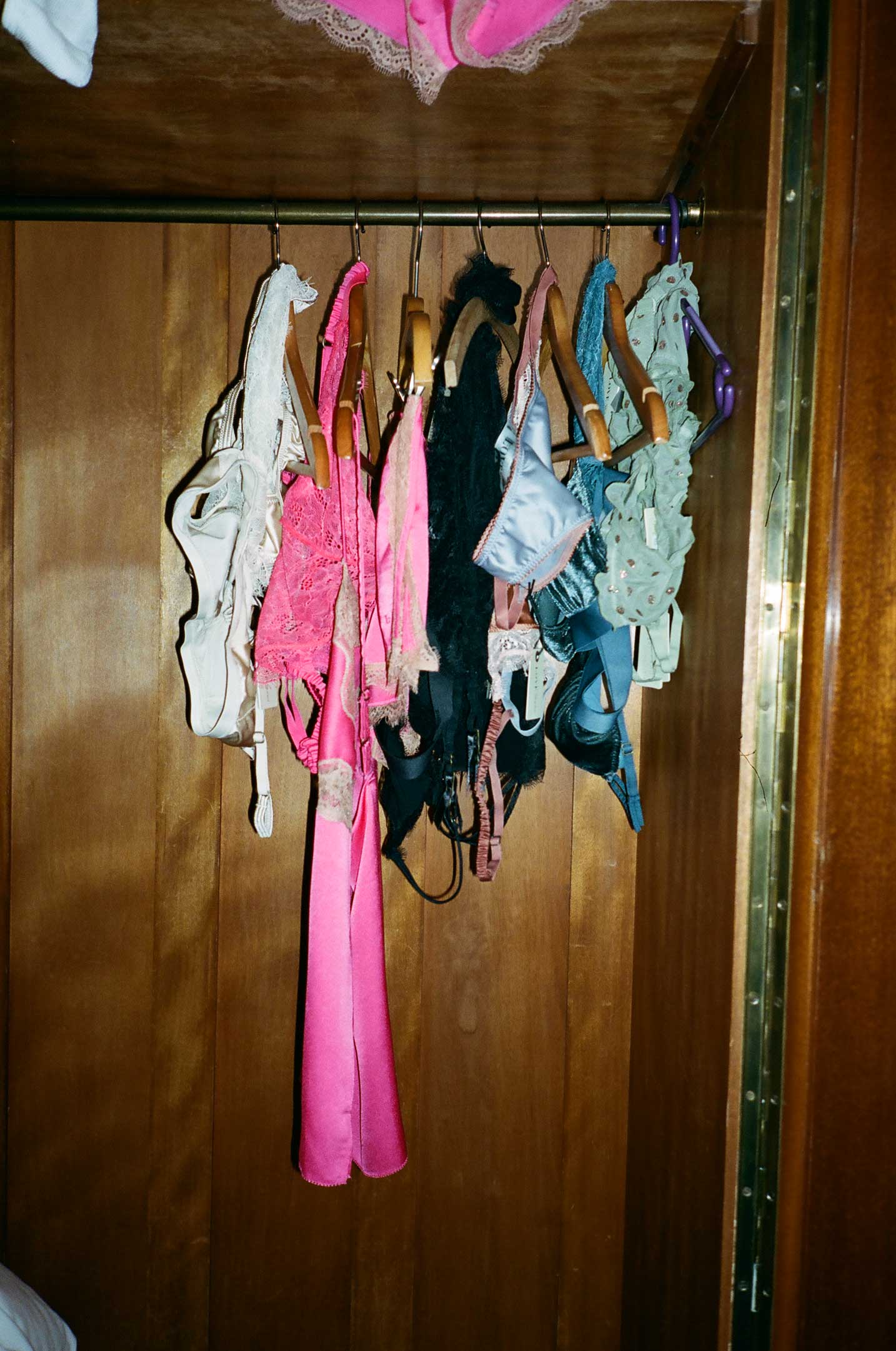 Lingerie hanging in a wooden closet