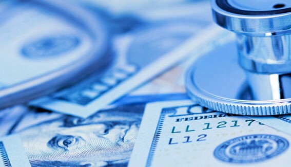 two female medical coders, one brunette and one blonde, working at computer monitors